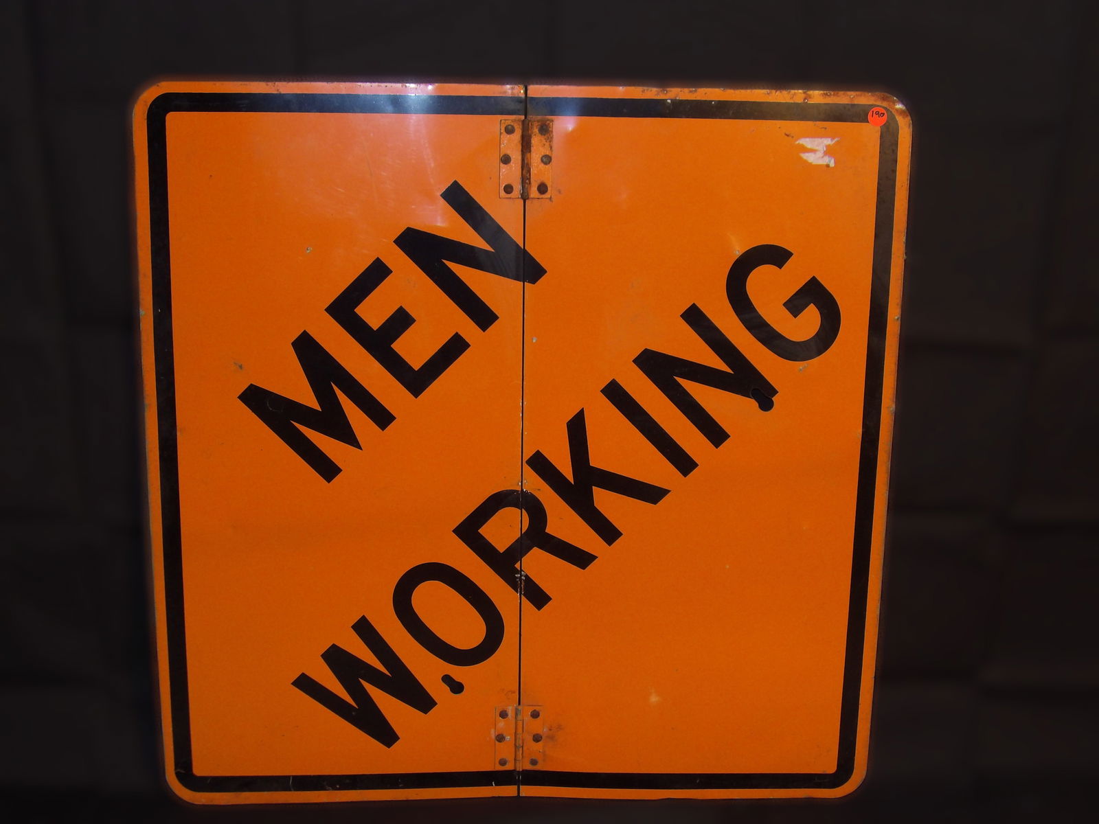 "Men Working" Folding Metal Sign: This "Men Working" sign folds for easy storage/transport. Measures 30" x 29.5". NO SHIPPING ON THIS ITEM.