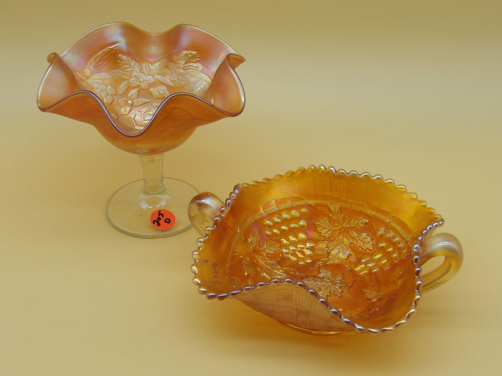 Northwood Marigold Grape & Cable Bon Bon Dish, Fenton Marigold Peacock & Urn Compote: This glass lot includes a Northwood Marigold "Grape & Cable" Bon Bon dish (2.5" x 7" x 5"), and a Fenton Marigold "Peacock & Urn" compote (5" x 6.5")