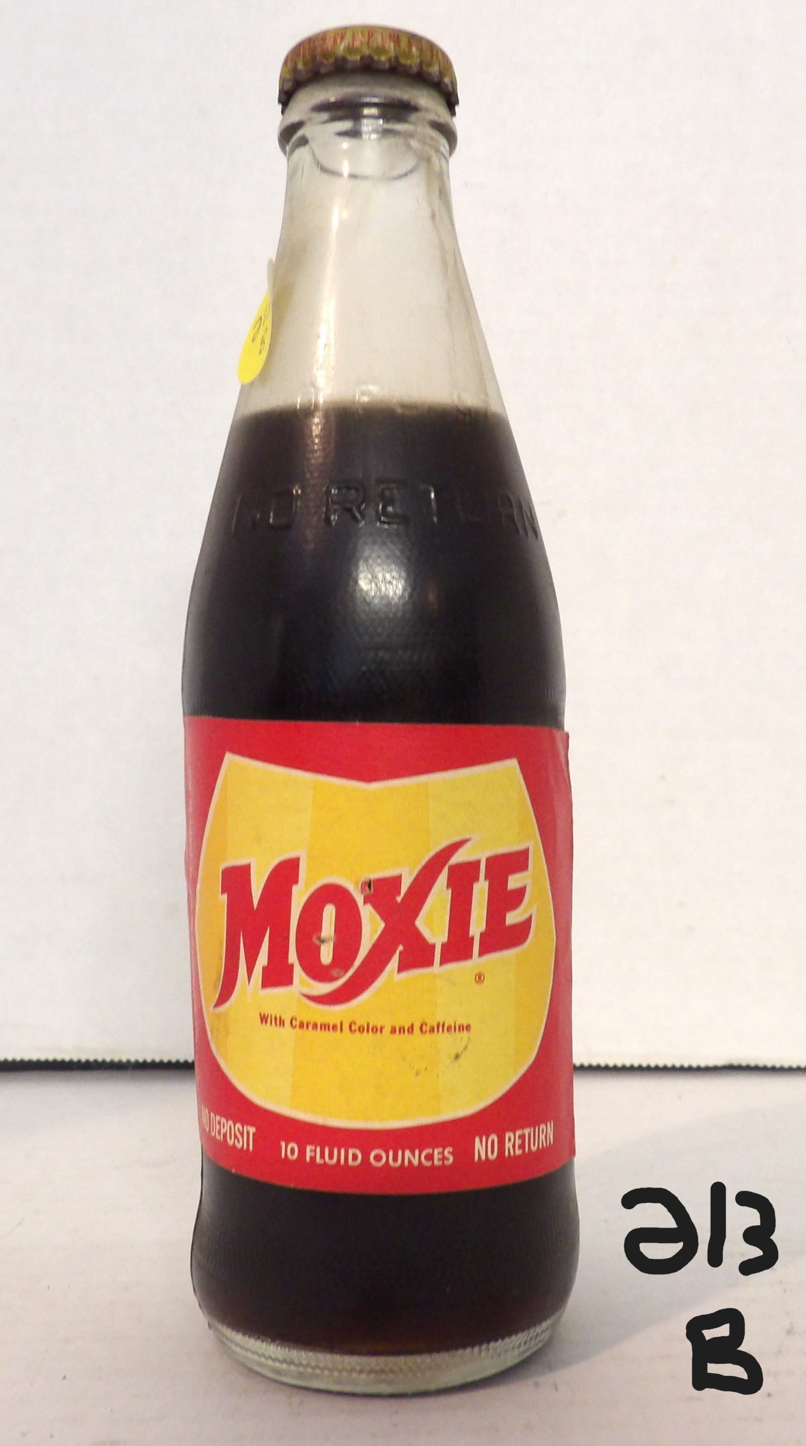 Moxie Soda Glass Bottle - Rare: This vintage Moxie soda glass bottle is sealed (contents still inside). Very rare label. Has minor wear, but is intact and looks great. 8"