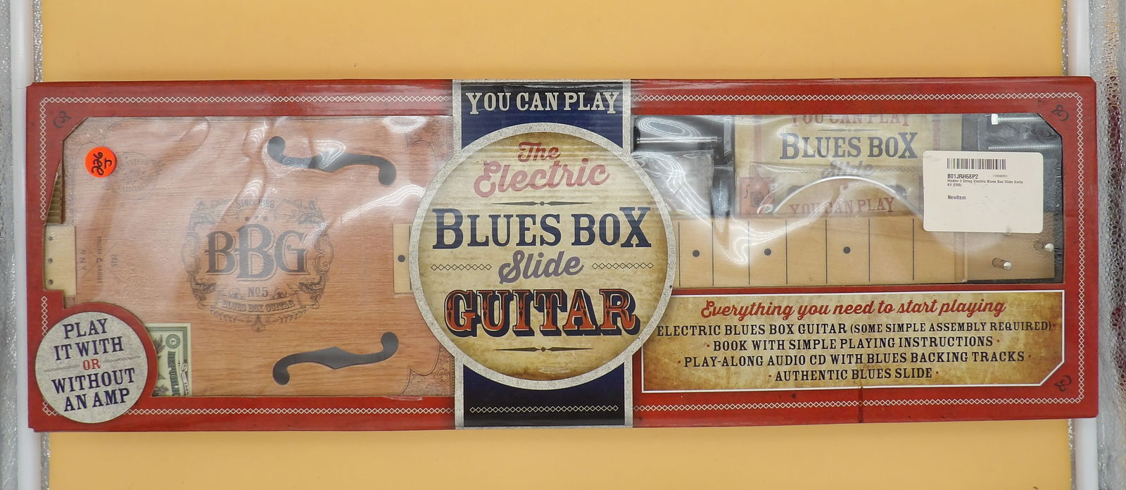 Electric Blues Box Slide Guitar: The "Electric Blues Box Slide Guitar" is a cigar box style guitar that comes with an easy lesson book, a backing track CD, and a slide. New In Box. Measures 26.5" x 8.5" x 2"
