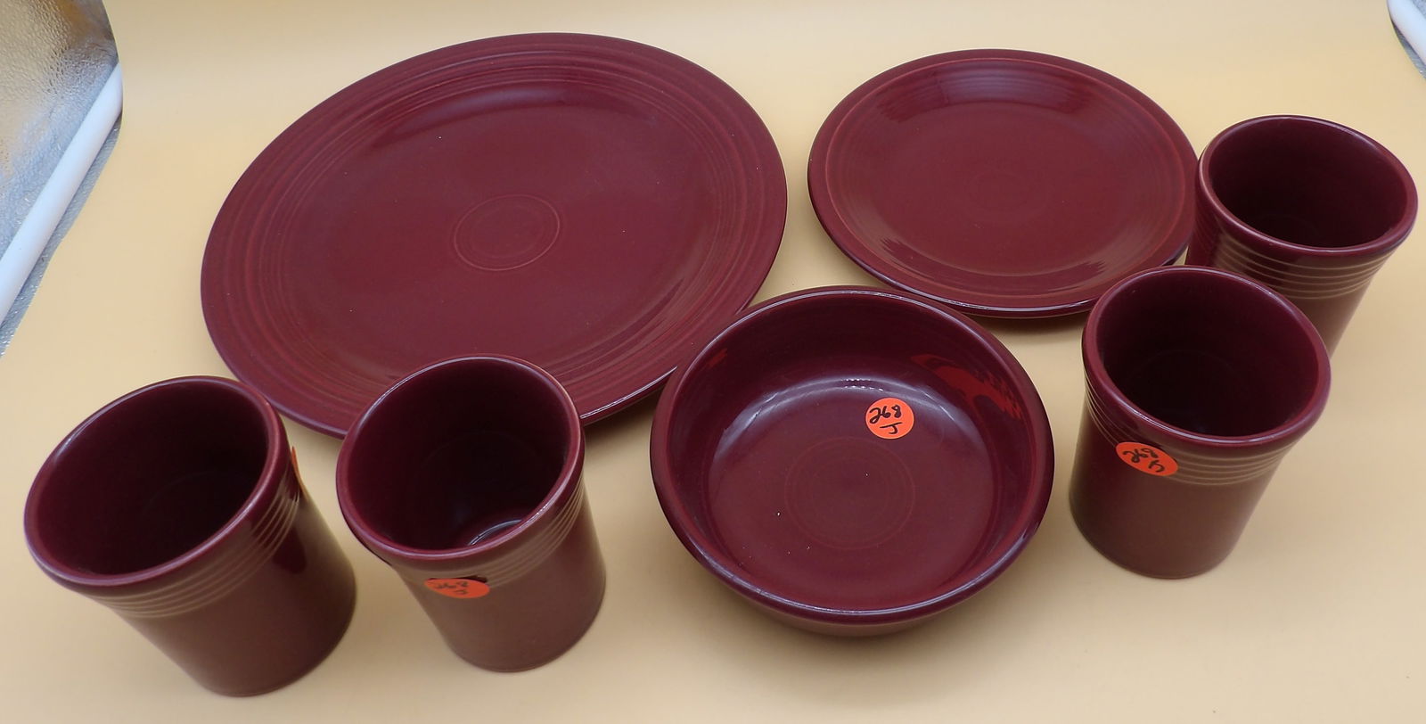 Fiestaware Plates, Bowl, Tumblers: This lot of modern-era Fiestaware includes 2 plates, 1 bowl, and 4 tumblers - all in Cinnabar color glaze. Measures 7", 10.5", 5.5", and 4" x 3"