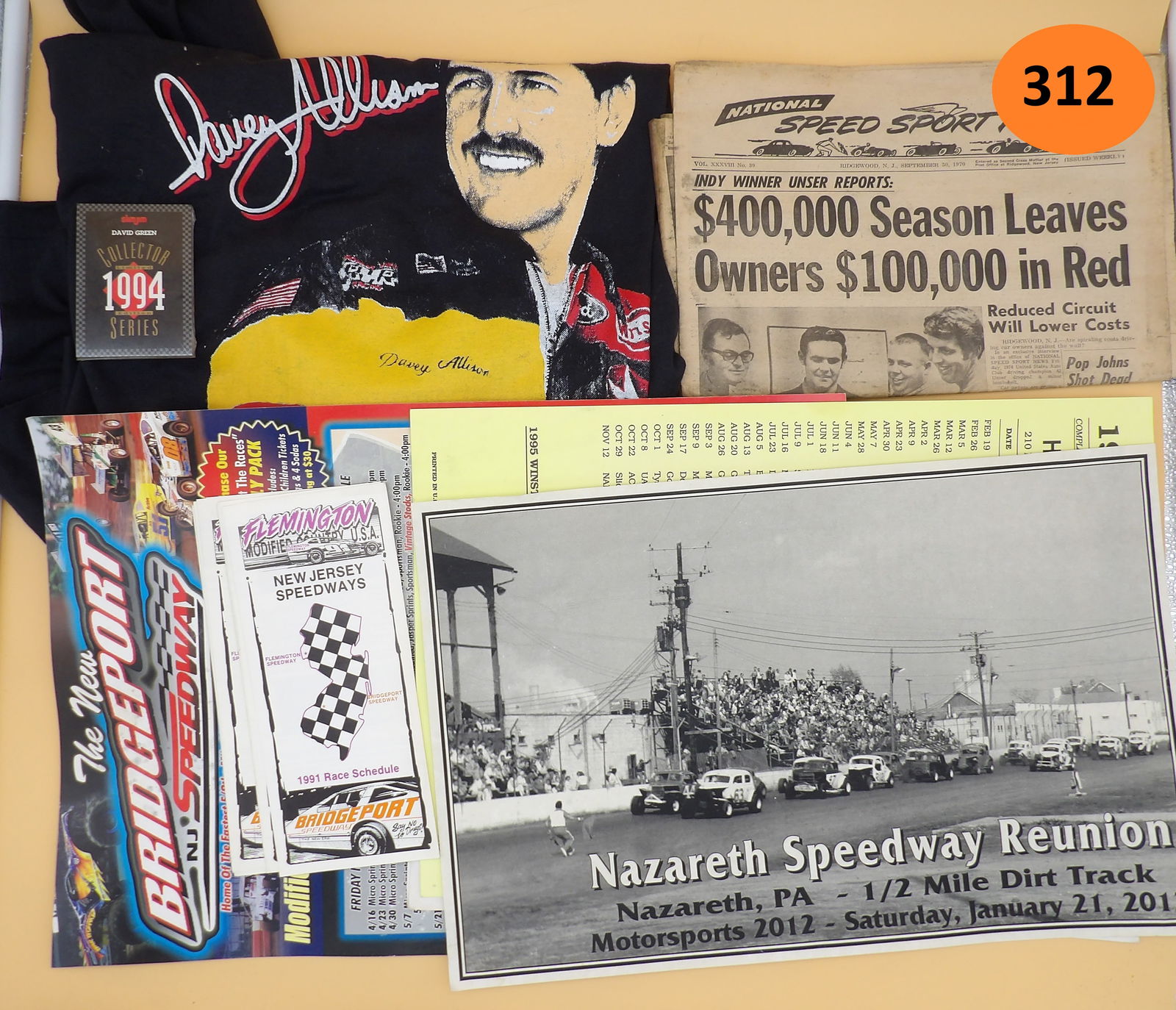 Race Lot - National Speedway Sport News, Allison T- Shirt, Race Schedules, Trading Cards: This vintage racing lot includes a 1970 issue of National Speed Sport News, a Davey Allison T-Shirt (XXL), five Bridgeport Speedway 1991 Race Schedules, Slim Jim David Green Trading Cards (sealed),