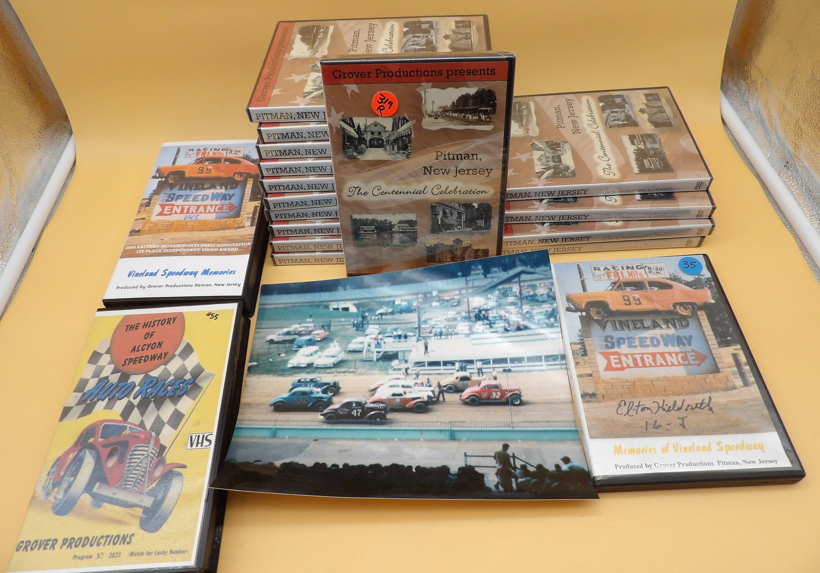 Vintage Racing & Pitman DVD / VHS / Photo: This lot includes a reprinted racing photo of Allentown Fairgrounds 1962, Vineland Speedway Memories VHS & DVD, a History of Alcyon Speedway VHS, and fifteen copies of Pitman NJ Centennial