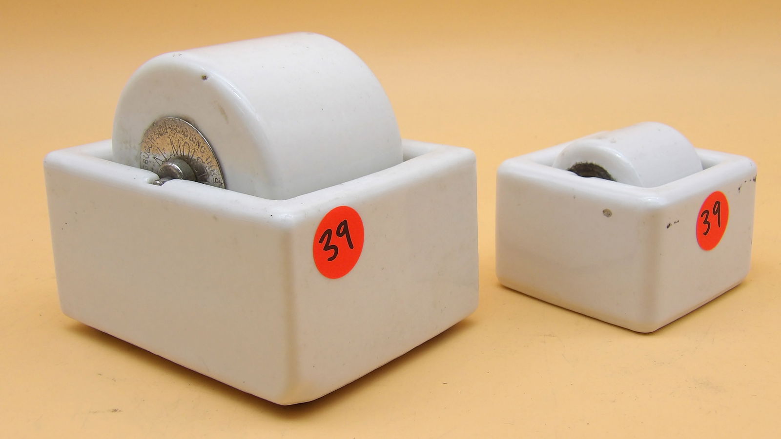 Sengbusch Porcelain Ideal Stamp Moistener & Frank A. Weeks Porcelain Stamp Moistener: This pair of porcelain stamp moisteners includes a Sengbusch Ideal (4" x 4" x 3.5") and a Frank A. Weeks (2.5" x 2.5" x 2.5"). Minor wear (see photos), but is intact and in working condition.