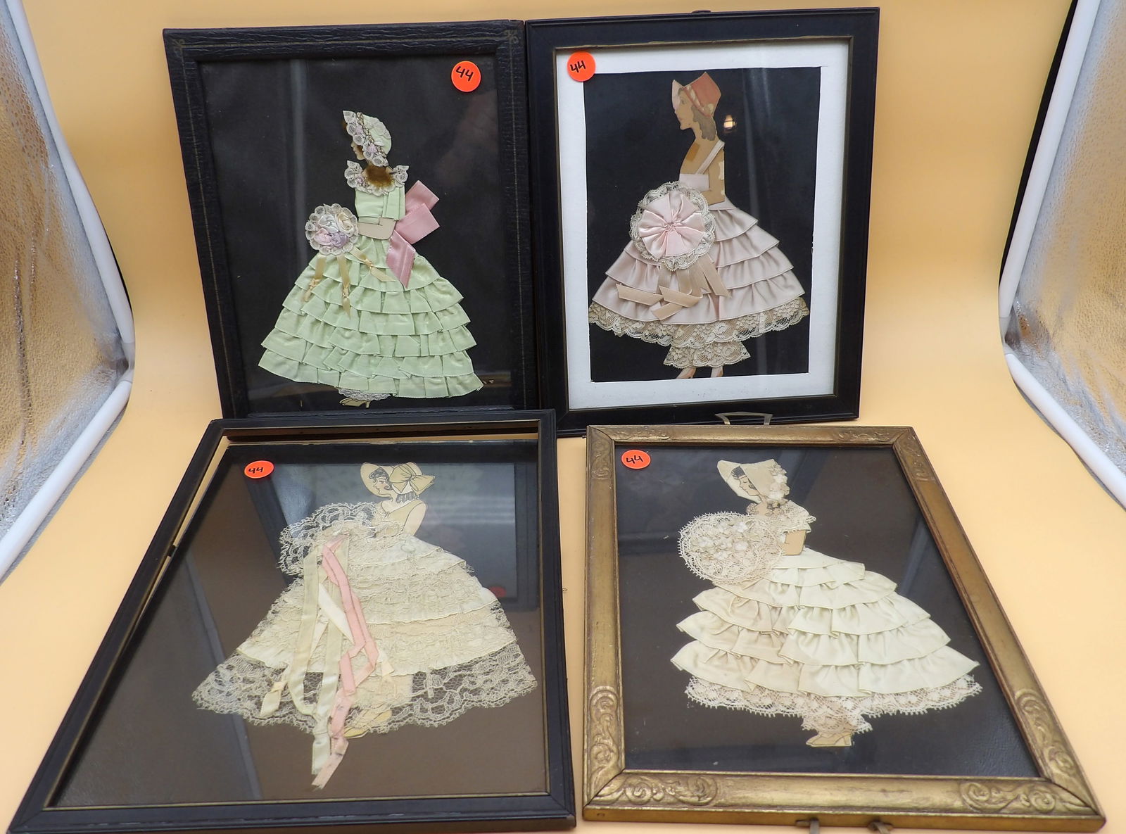 Framed Ribbon Dolls (4): This collection of 4 vintage 1920's ribbon dolls are made with real dress cloth. Measures 12" x 9.5", 13" x 9", and 11.5" x 9.5".