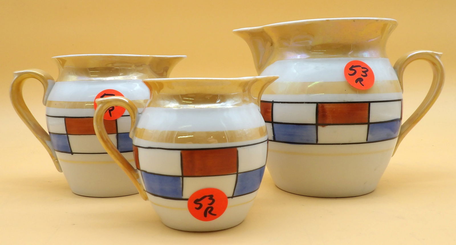 Union K Czech Lusterware Creamer Set (3 pcs): This trio of Czechoslovakian Union K Lusterware creamer pitchers comes with a distinctive Art Deco Geometric pattern. 1920's / 30's. Measures 4.5" x 5.5" x 3.5", 4" x 4.5" x 3", and 3" x 4" x 2.5"