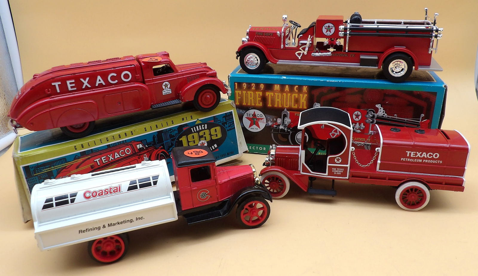 Texaco / Coastal Diecast Truck Banks (4): This collection of 4 diecast truck banks includes a Texaco 1929 Mack Fire Truck (3.5" x 10" x 4" In Box), a Texaco 1939 Dodge Airflow (3" x 3" x 9" - In Box), a Texaco 1919 GMC Tanker Truck (3.5" x