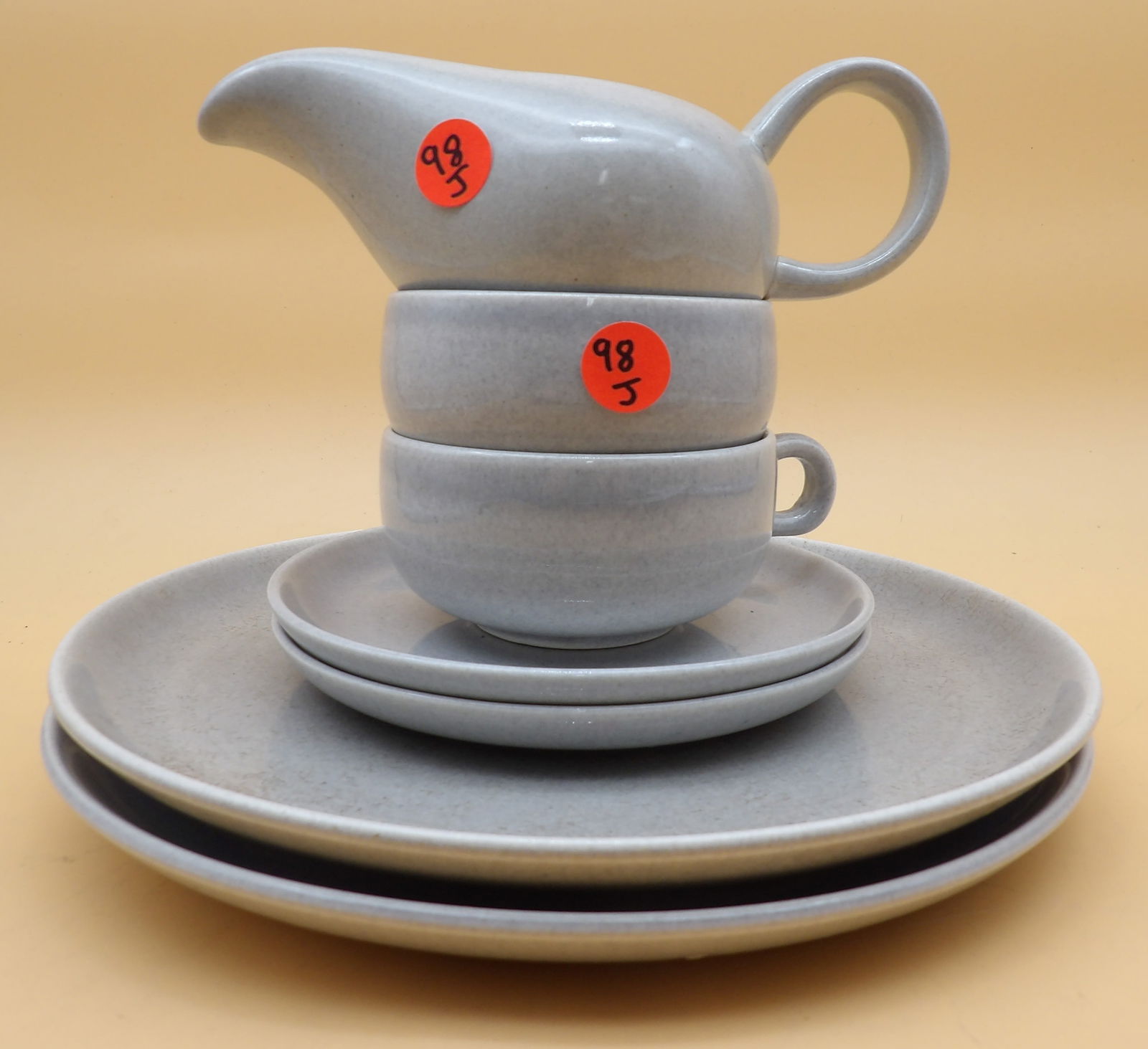 Russel Wright Dishes, Cups, Creamer: This 7 piece Russel Wright collection includes 2 large dishes (10"), 2 small dishes (6"), 2 cups (2" x 5" x 4"), and 1 creamer (3" x 7" x 3"). 1950's.