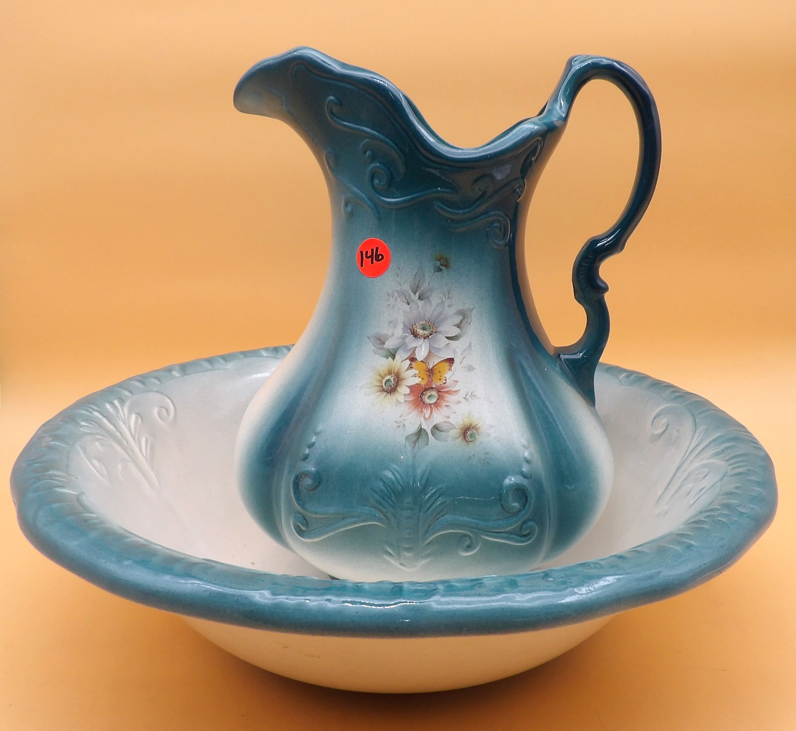 Ironstone Pitcher / Basin: This lovely Ironstone pitcher/basin combo features floral motif. Measures 12" x 8.5" x 4.5" and 4.5" x 15.5"