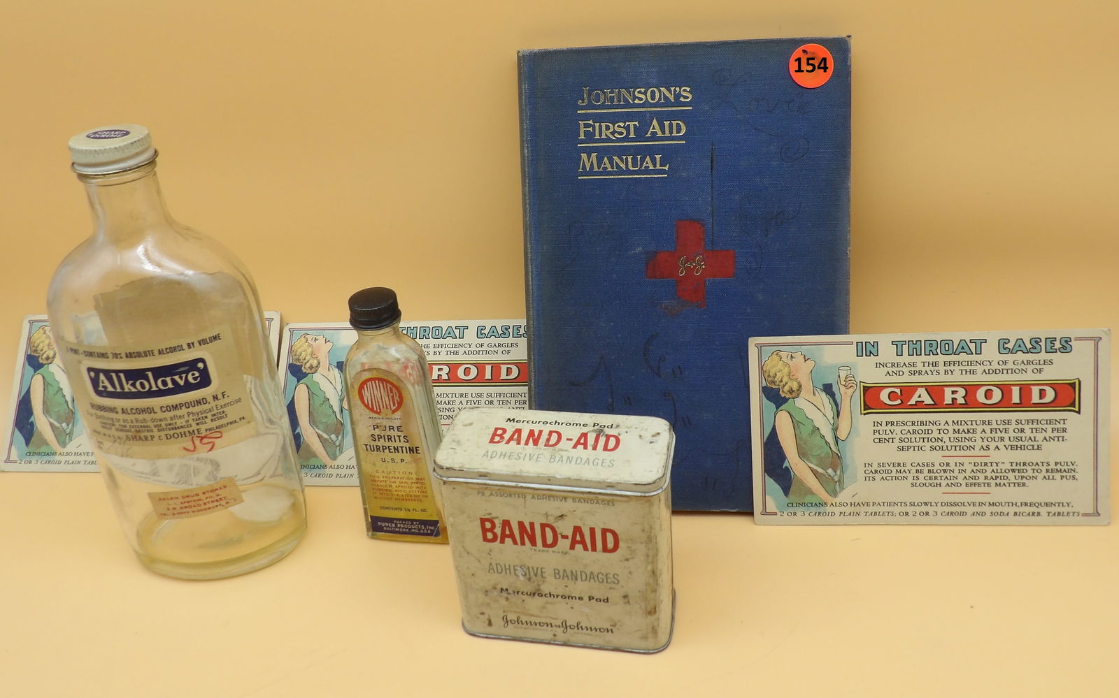 Vintage Medicine / First Aide Lot: This medicinal-themed lot includes 3 advertisement cards for Caroid Medicine Tablets (1 w/ pencil writing on edge - 6" x 3.5"), a vintage Band-Aid tin w/ adhesive tape and two plastic strip band aids