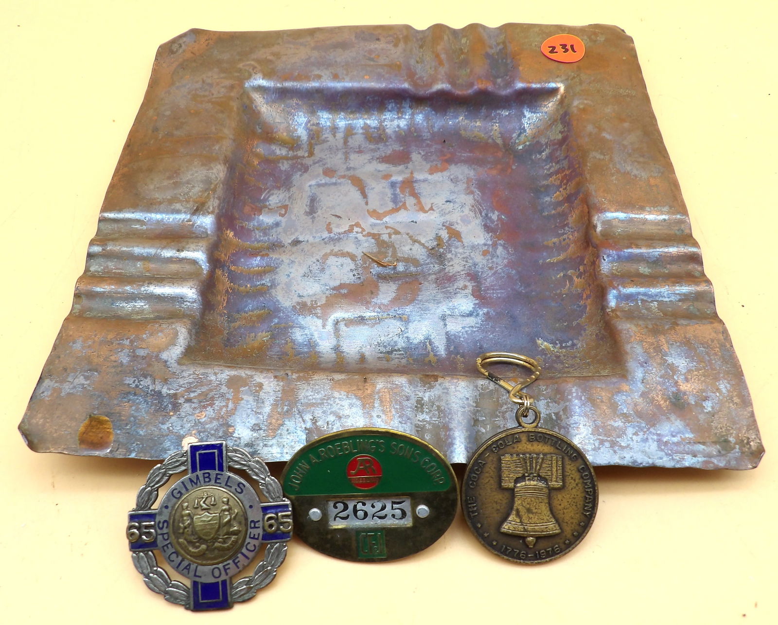 Gregorian Copper Square Tray / Gimbel's Special Officer Badge / John A. Roeblings and Sons Corp.: This lot of vintage keepsakes from the beginnings of corperate America include a solid copper 9x9 ashtray from Gregorian Copper, a Gimble's Department Store 2" Special offer badge, a John A. Roeblings