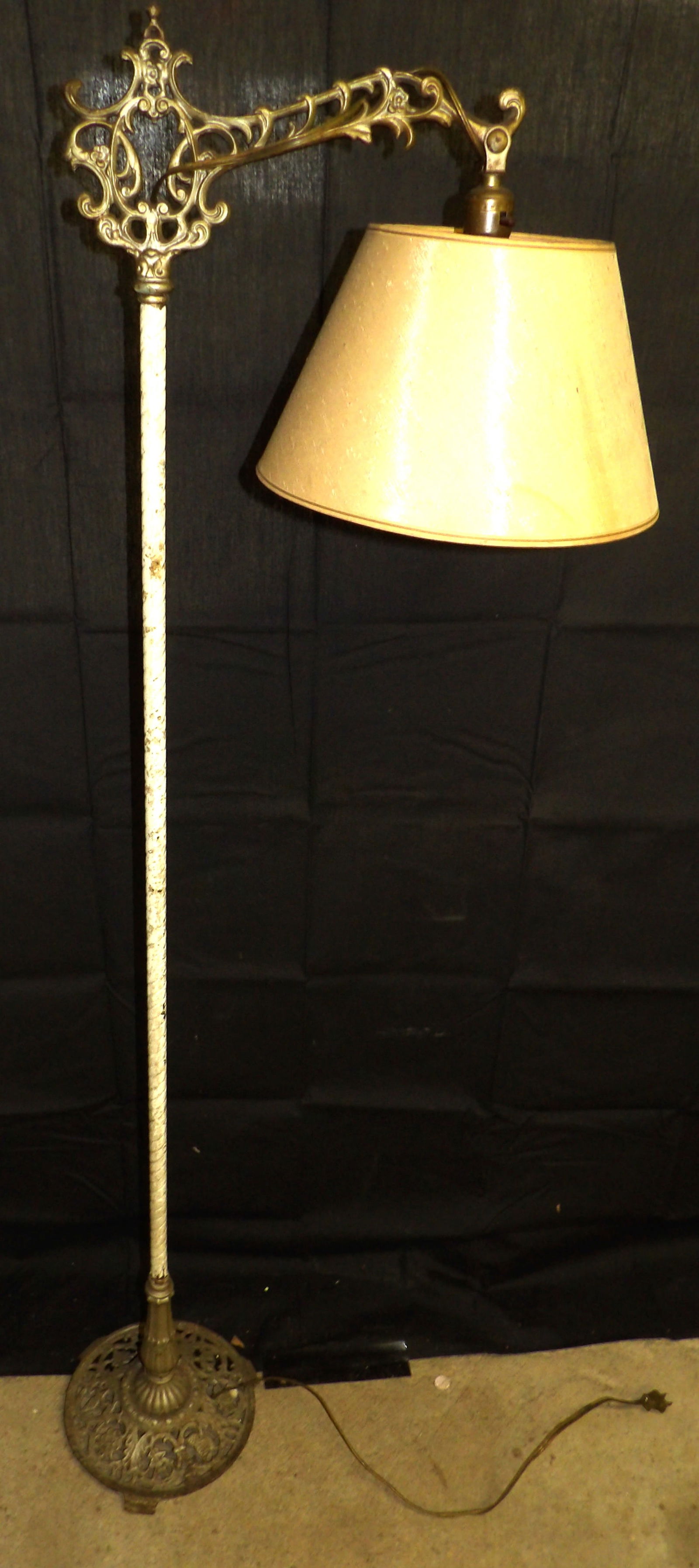 Standing Living Room White Painted Ornate Floral Accent Lamp: A beautifully ornate metal standing accent lamp that contains it's original fixtures and lampshade. It also has a base that features vines and leaves. It stands at 58" tall and 15" wide.