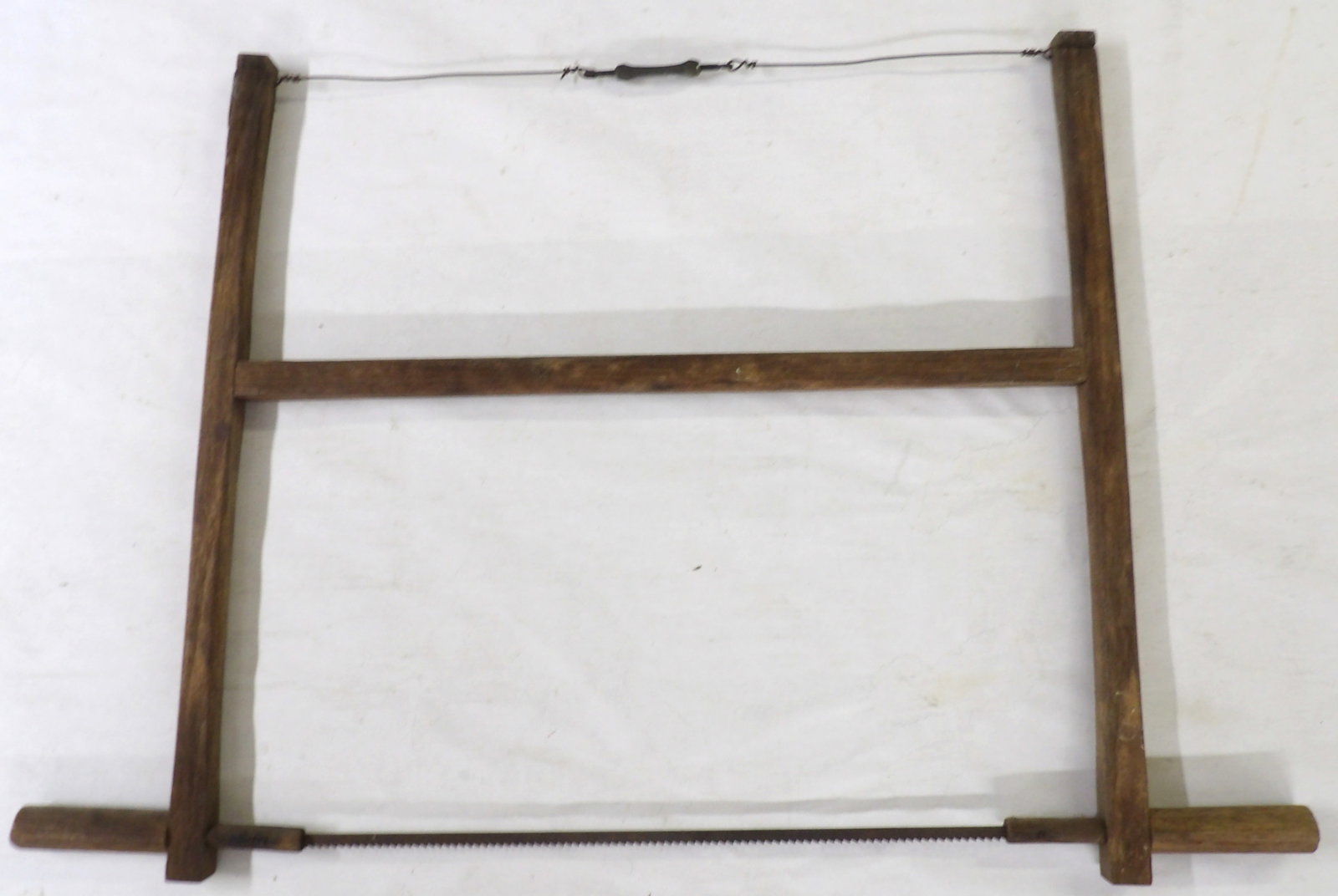 Antique Wooden Primitive Buck Saw / Bow Frame Saw: This antique primitive-style buck/bow saw was generally used to cut firewood. Measures approx. 22" x 32". NO SHIPPING ON THIS ITEM