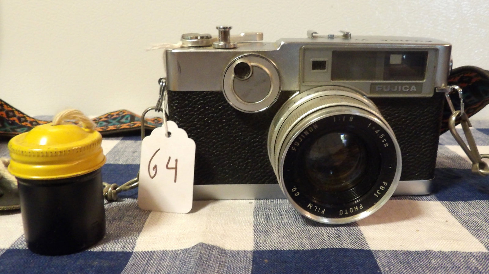 Fujica V2 - Fuji Film Camera: This vintage Fuji Film camera features a strap and film-case. Measures 6" x 3.5" x 3"