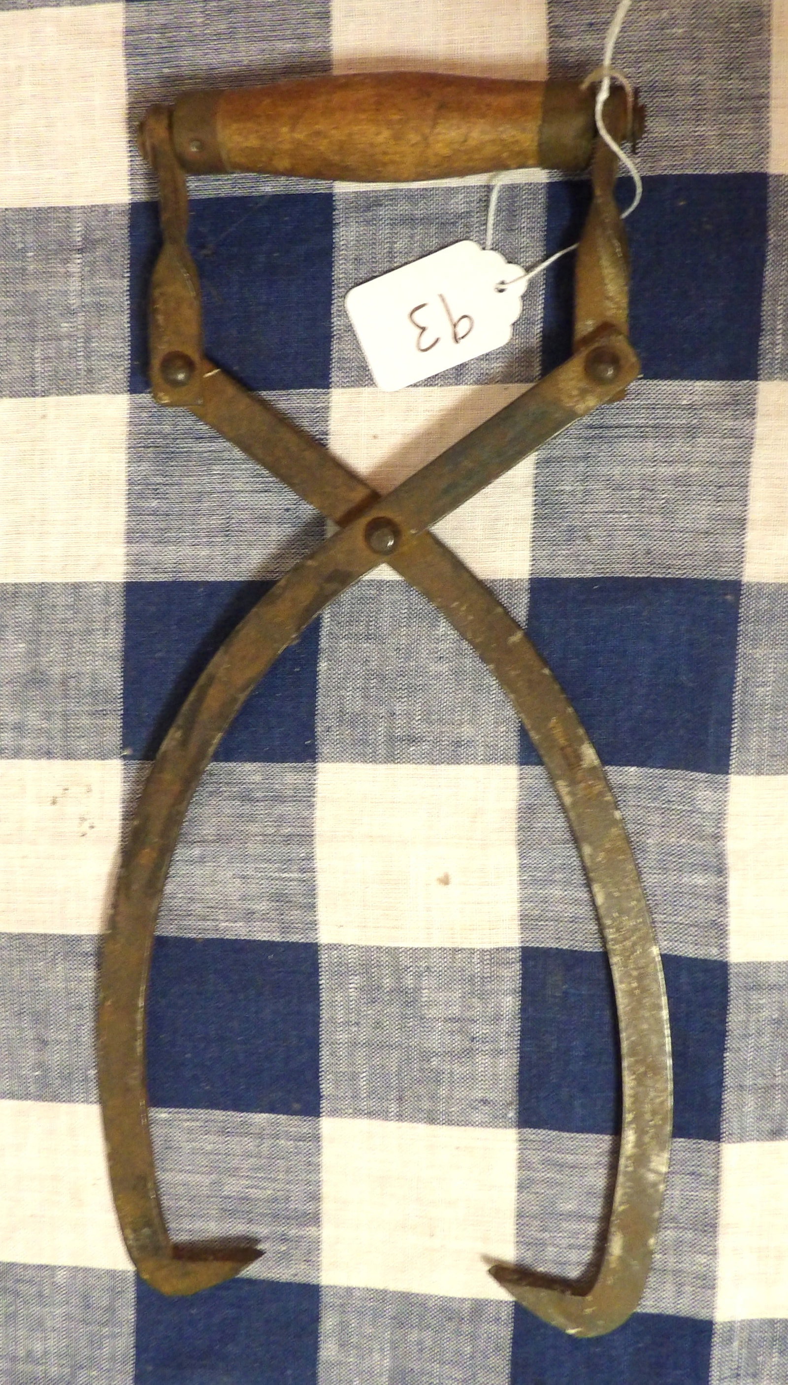 Metal Tongs: These vintage metal tongs feature a wooden handle. Measures 13"