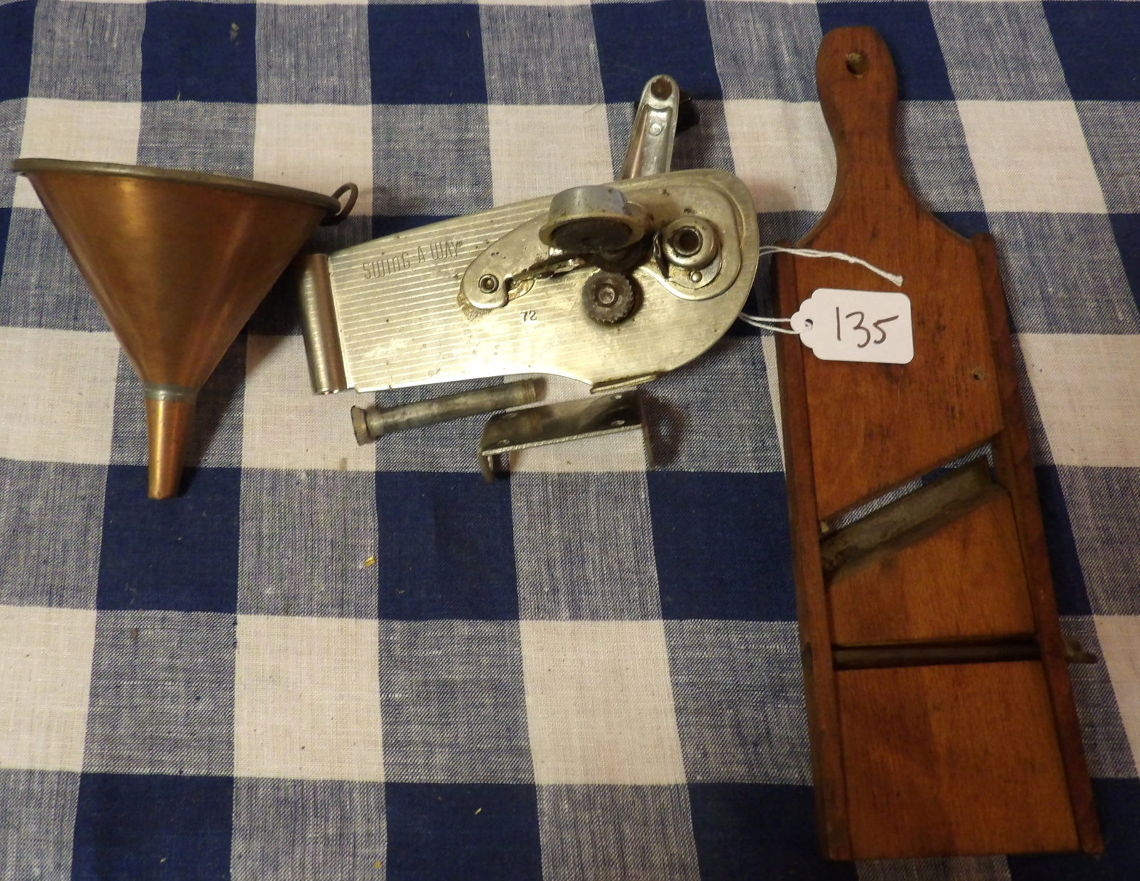 "Swing A Way" Mountable Can Opener, Slicer, Brass Funnel: This kitchen lot includes a "Swing A Way" Mountable Can Opener, a Slicer, and a Brass Funnel .