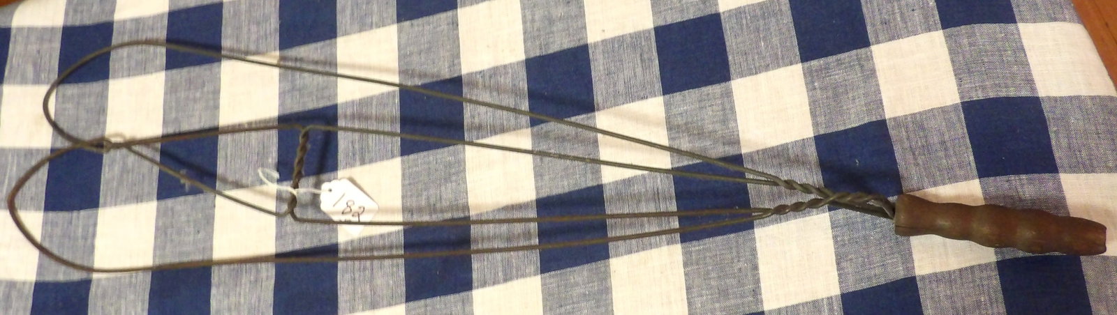 Antique Rug Beater: This antique rug beater features a metal wire body with a wooden handle. Measures 31"