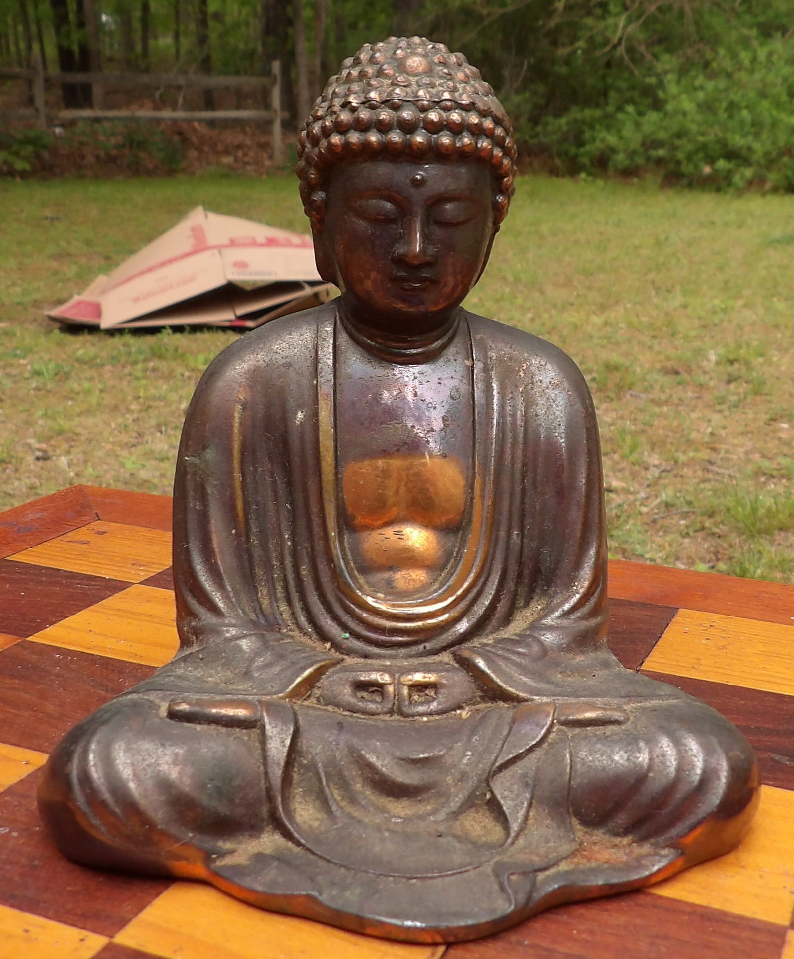 Bronze Buddha Statue: This bronze Buddha figurine features a classic seated meditation posture, consistent with antique Japanese style examples