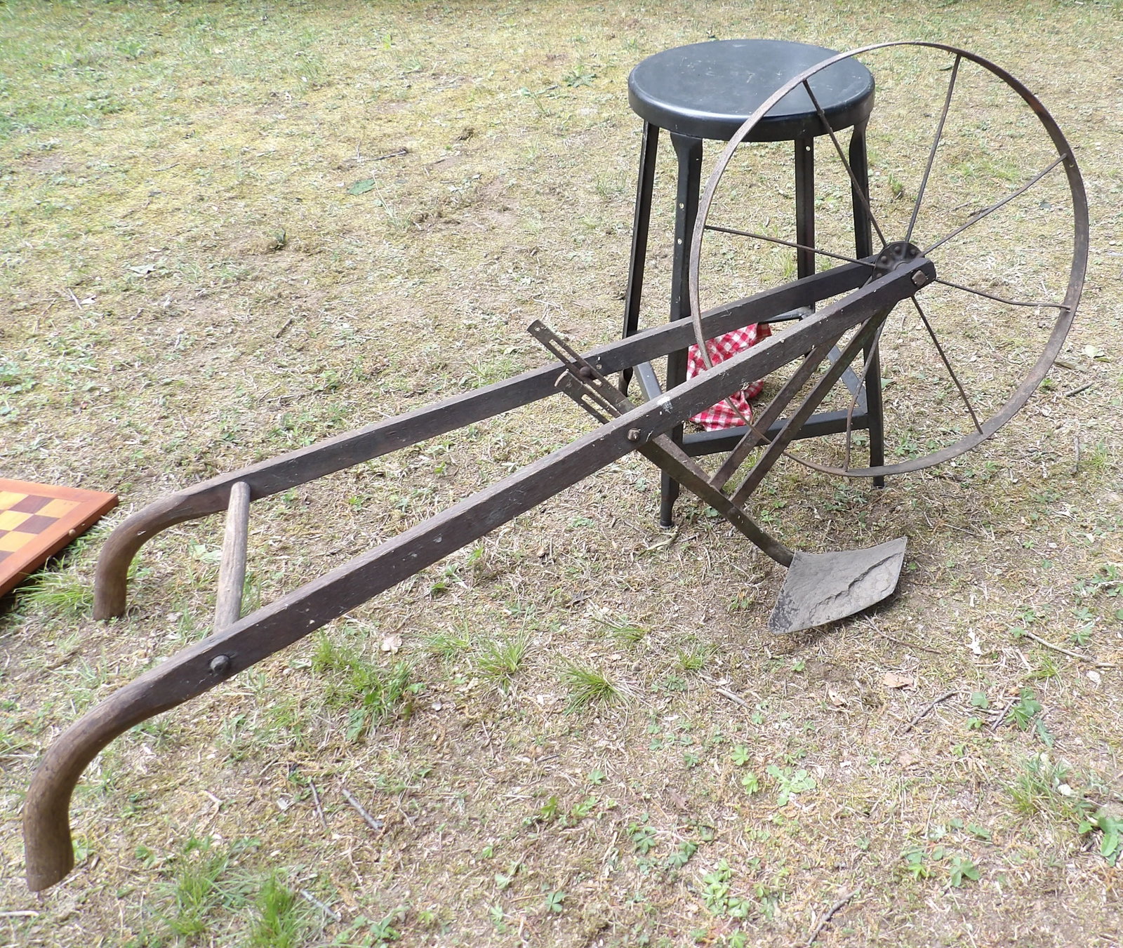 Single-wheel Garden Push Plow: This lot features a vintage single-wheel garden push plow originally used for cultivating and preparing soil. NO SHIPPING ON THIS ITEM - PICK UP ONLY