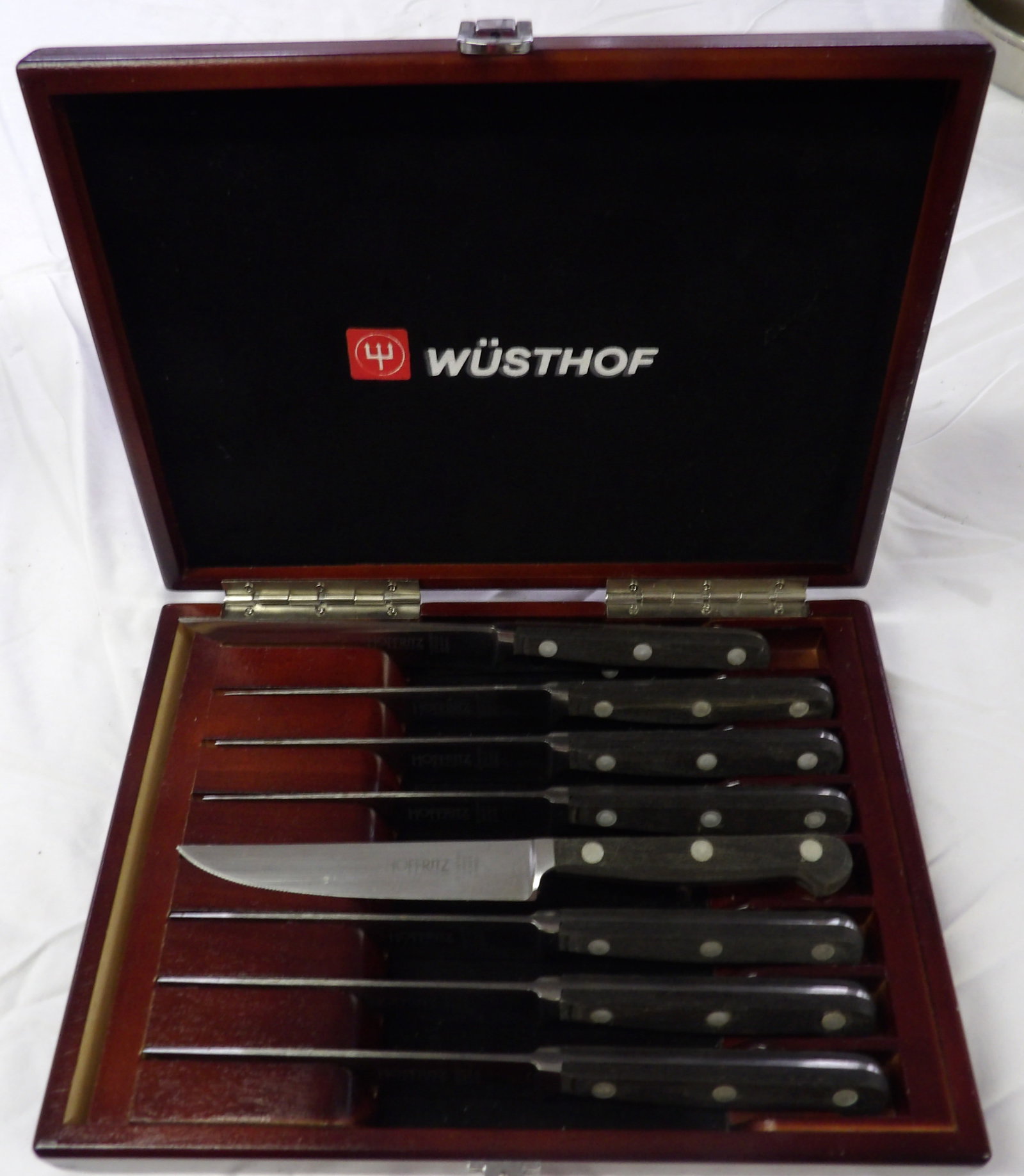 Wusthof / Hoffritz Knife Set: This 8 piece Wusthof / Hoffritz knife set comes in a wooden holding case. Measures 8" x 11" x 2"