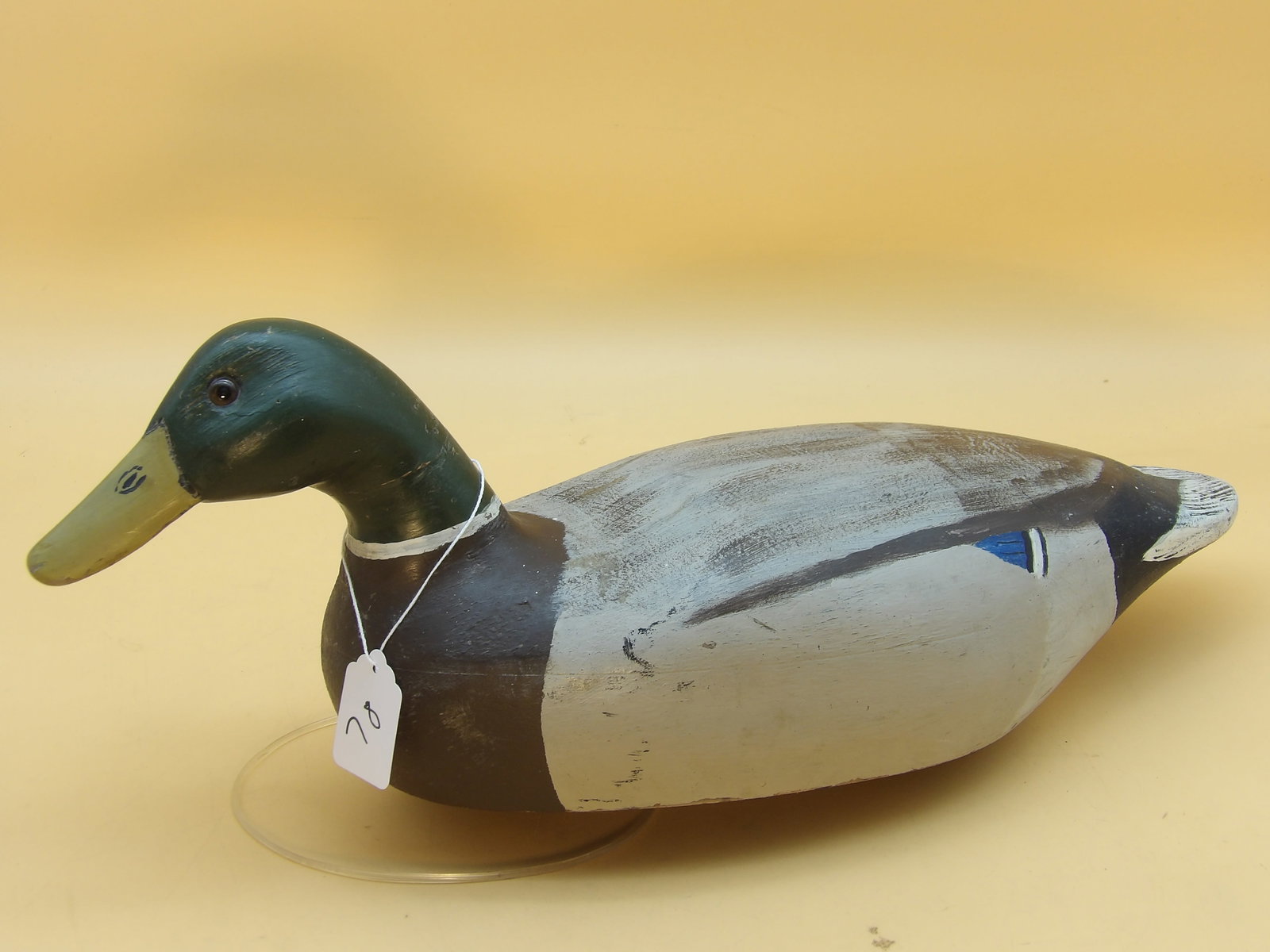 "Mallard" Wood Carved Metzger Duck Decoy: This detailed wood carved decoy was created by renowned area decoy artist Lawrence Metzger. A repair has been made to the neck. Measures approx: 7.5" x 19" x 6"