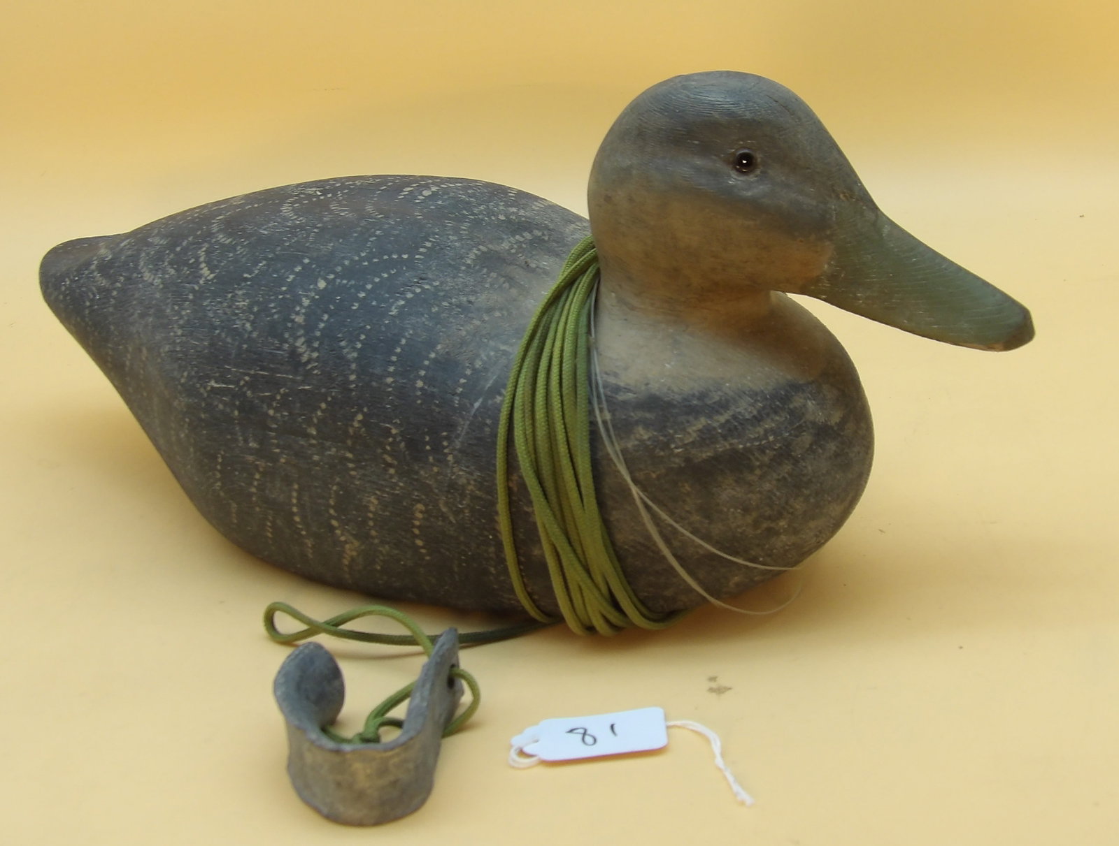 American Black Duck Wood Carved Metzger Decoy: This detailed wood carved duck decoy was created by renowned area decoy artist Lawrence Metzger. Includes lead line and weight. Measures approx: 7" x 16" x 6"