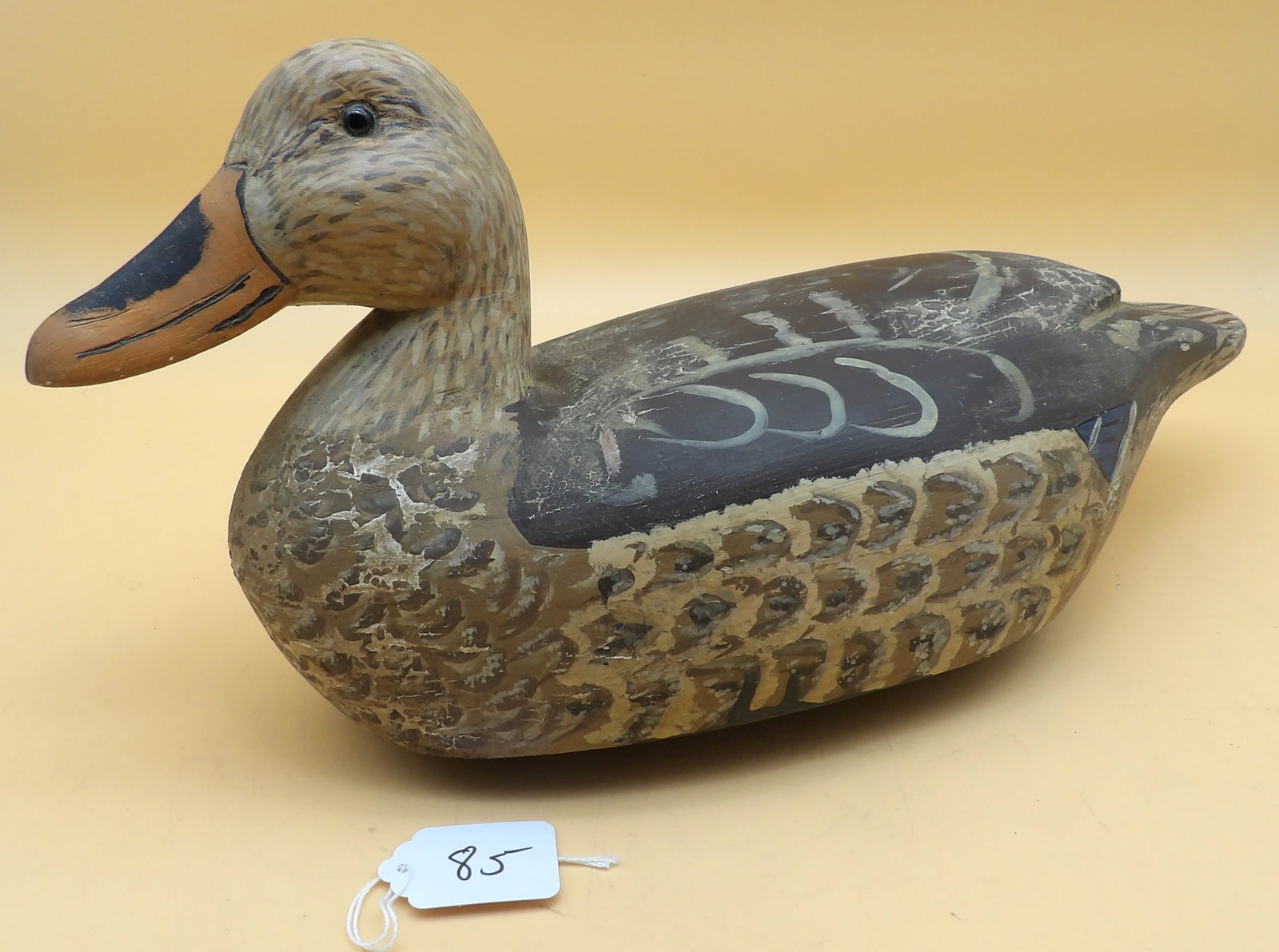 "Mallard Hen" Wood Carved Metzger Duck Decoy: This detailed "Mallard Hen" duck decoy was created by renowned area decoy artist Lawrence Metzger. Has a repair to neck. Measures approx: 8" x 16" x 6"