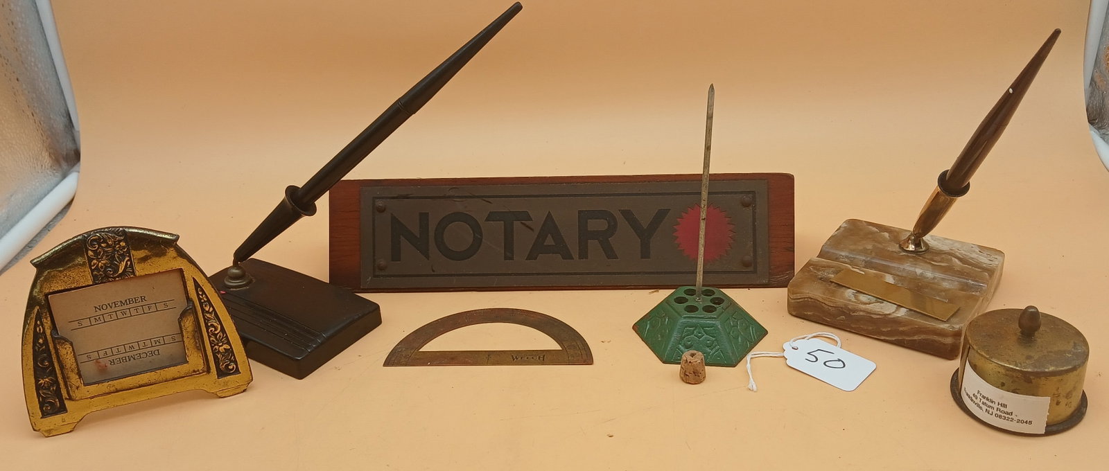 Vintage Desk Items (7 pcs) - Fountain Pens, Notary, Protractor, more: This vintage desk item collection includes 2 Sheaffer Fountain Pens w/ stands, a "Notary" desk plaque, a desk calendar, a label dispenser, a brass protractor, and a cast iron paper spike.