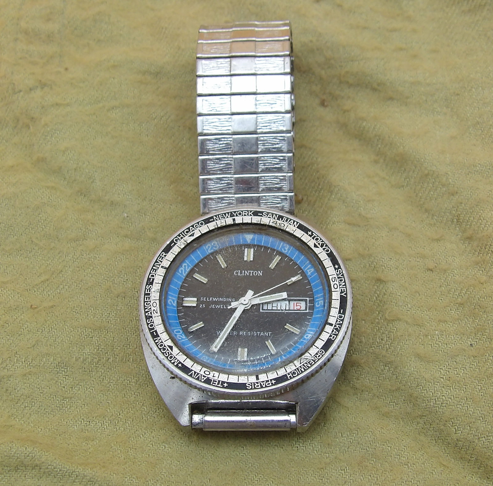 Clinton World Time 25-Jewel Automatic Watch: This Clinton World Time 25-Jewel Automatic Watch is shock & water resistant. Missing crown stem, but is otherwise intact.