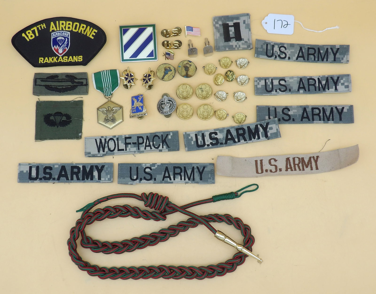 Military Patches, Pins, Badges, Buttons, Cuff Links, Shoulder Cord (40+ pcs): This vintage military collection includes over 40 pieces that include uniform buttons, uniform patches, pins, cuff links, service medal, and a French Fourragere braided shoulder cord.