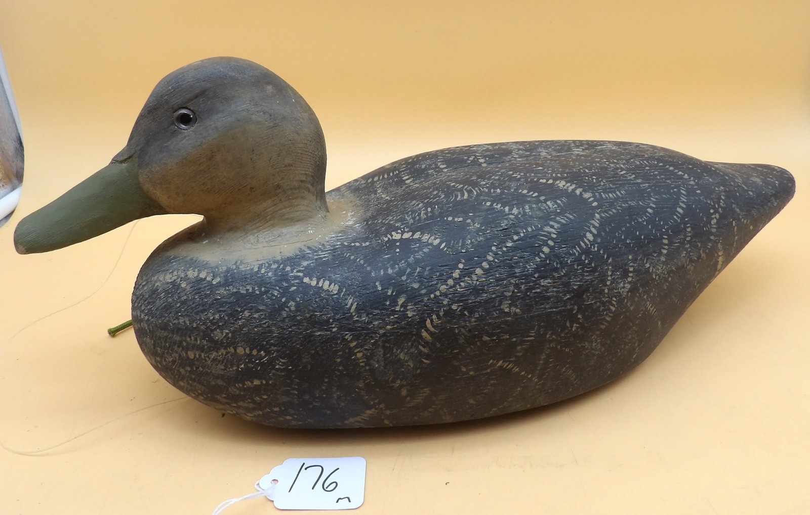 "Black Duck" Wood Metzger Duck Decoy: This "Black Duck" wood decoy was made by renowned area carver Lawrence Metzger. Includes lead line and weight. Measures approx: 7" x 16" x 6"