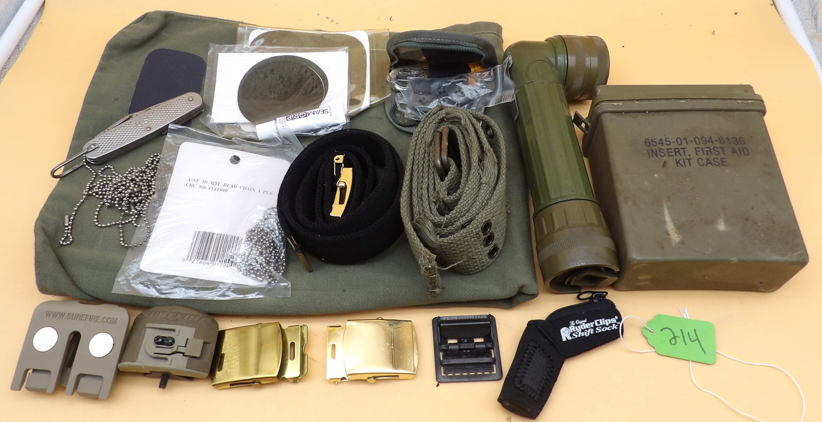 US Army First Aid Kit, Belts, Knife, Flashlight, Accessories: This vintage US Army military lot includes a duffle bag (has stains / wear), a full First Aid kit, 2 belts, belt buckles, a sewing repair kit, repair patches, beaded necklace chain (for dog tags
