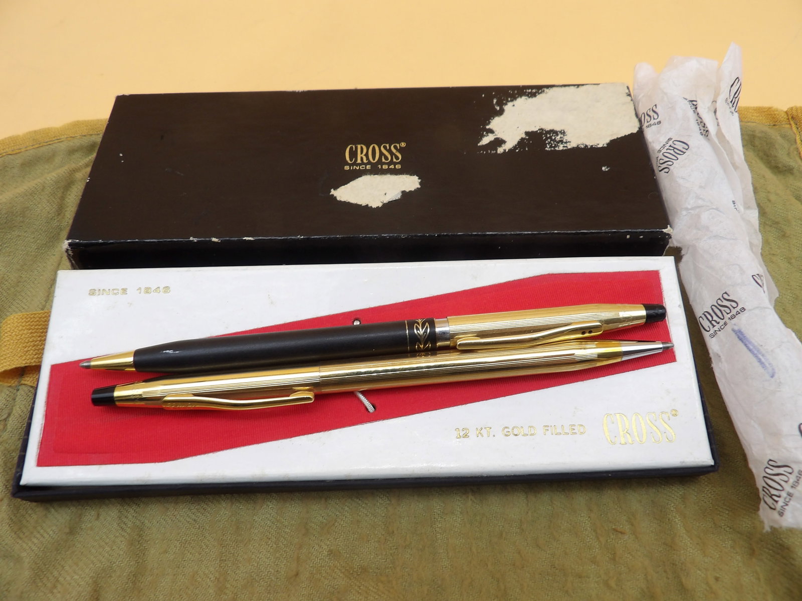 Cross Gold Filled Pens (2): This lot features two Cross brand pens- each 1/20 12k gold filled and in Cross case. One pen has glue residue near top (see photo), but can be removed with some care. Otherwise intact and in great