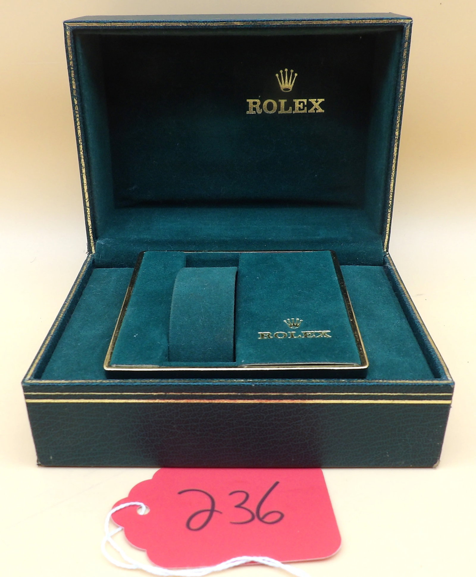 ROLEX Watch Box: This 1970's era Rolex watch box features intact green velvet insert and removable watch holder. Minor wear to outside corner of box (see photos). Measures approx: 3" x 5.5" x 4"