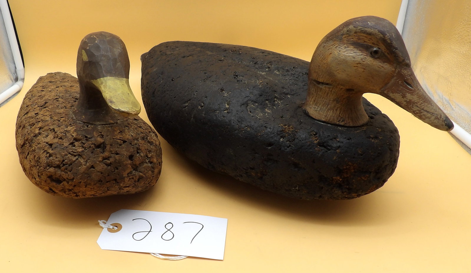 Wood / Cork Duck Decoys: This pair of duck decoys feature wooden heads with cork bodies. From the collection of renowned area decoy artist Lawrence Metzger. Measures approx 8" x 19" x 9" and 7" x 14" x 6".