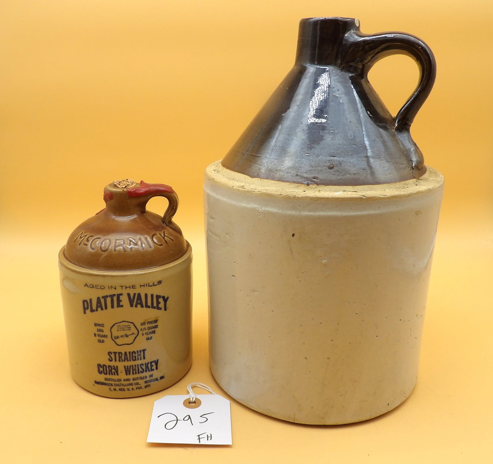 Stoneware Jugs (2): This pair of vintage stoneware jugs includes one by McCormick (7" x 4") and one unbranded (12" x 7"). NO SHIPPING ON THIS ITEM - PICK UP ONLY