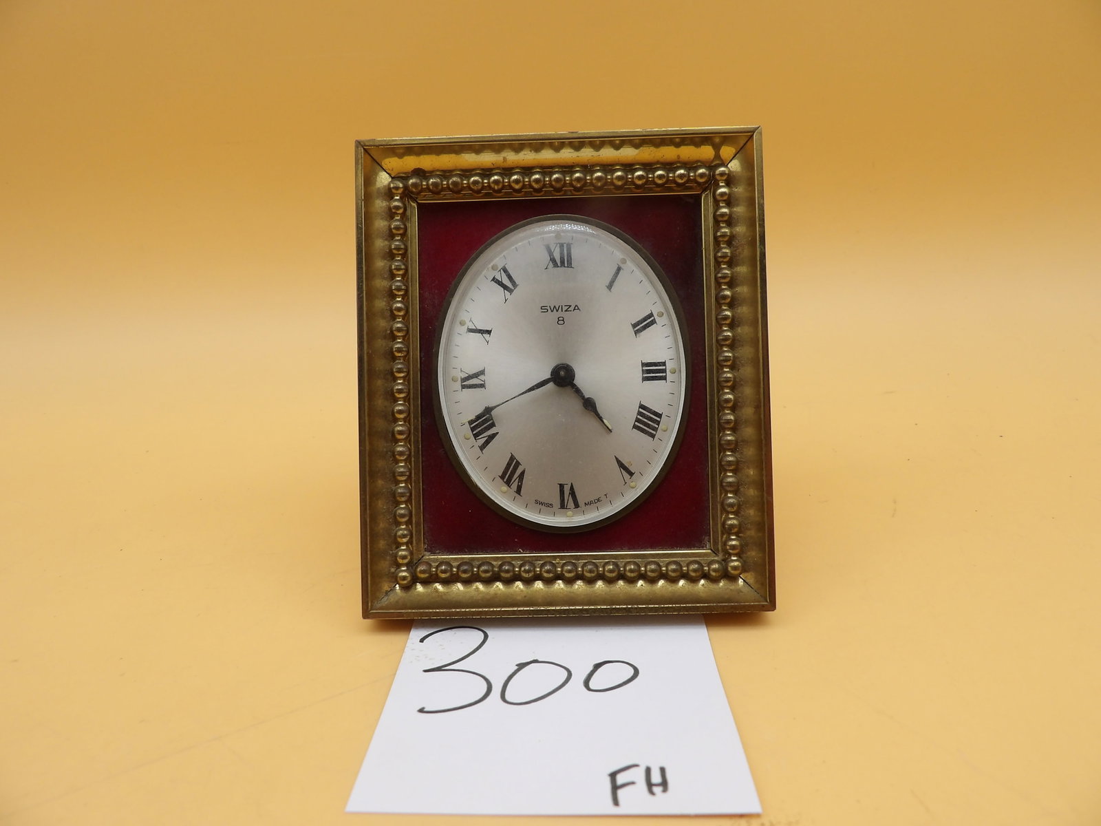Swiza 8 Day Alarm Clock: This vintage Swiss-made Swiza 8 Day Alarm Clock features a brass frame with beaded detailing. Is in working condition - keeps time and alarm bell is loud and clear. Measures approx: 4" x 3.5"