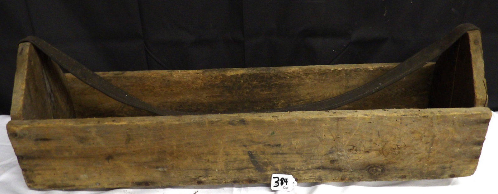 Antique Wood Tool Carrier Box: This Antique Wood Tool Carrier Box features a leather strap. Has damage to bottom (see photos), but is sturdy and otherwise intact. Measures approx 10" x 31" x 8". NO SHIPPING ON THIS ITEM - PICK UP