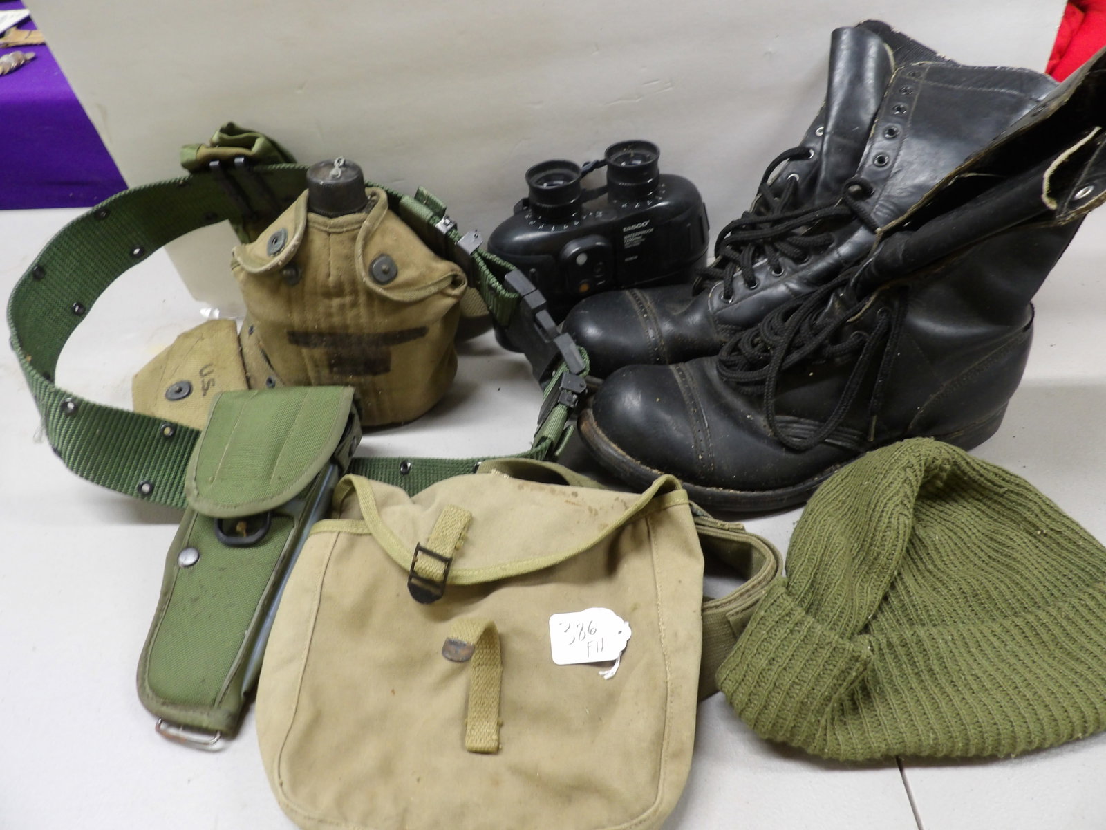 US Military Lot (7 pcs): This US Military Lot includes a metal canteen in case, a holster, a pair of Tasco waterproof binoculars, ammo bag & pouch, a pair of boots (size 12), and a wool cap. NO SHIPPING ON THIS ITEM - PICK