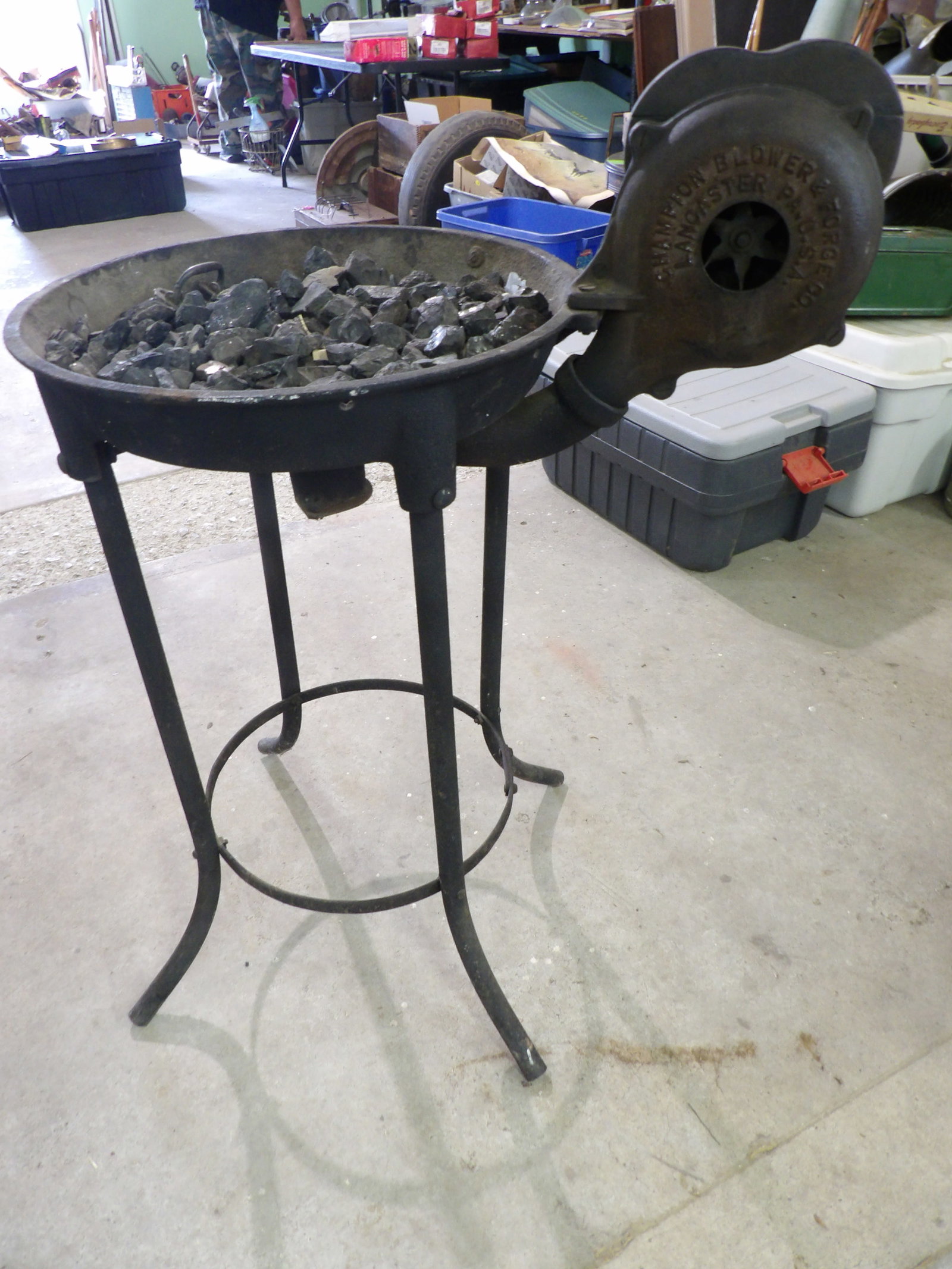 Champion Cast Iron Forge: This portable blacksmith forge features a working hand crank. Made by Champion Blower & Forge Co. Measures approx 38" tall. NO SHIPPING ON THIS ITEM - PICK UP ONLY