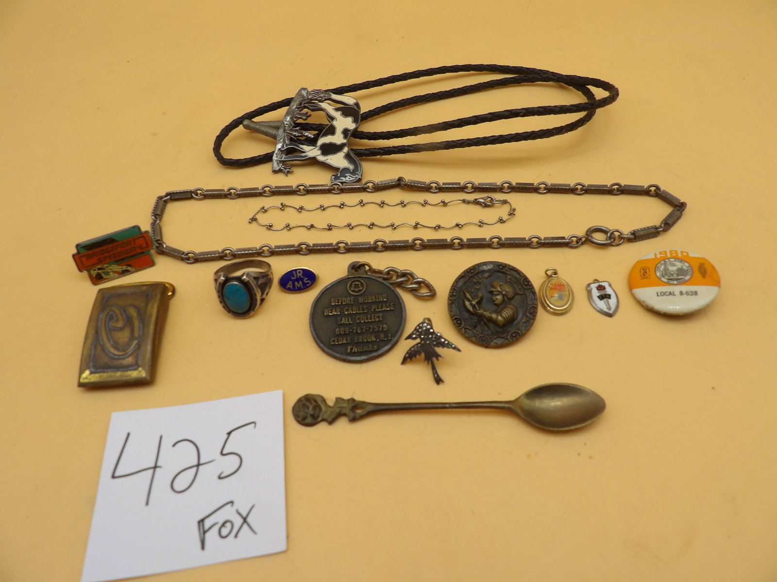 Jewelery, Buttons, Bolo Tie: This 14 piece lot includes a bolo tie (horse), a turquois horseshoe ring, necklaces, pins, pendants, and a collectible spoon.