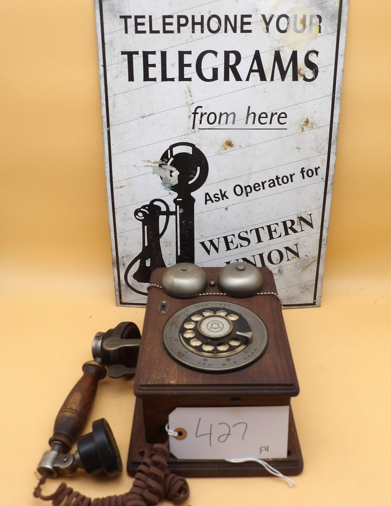 Country Junction Telephone & Western Union Sign: This lot features a vintage Country Junction wall-mounted telephone and a vintage metal Western Union sign. NO SHIPPING ON THIS ITEM - PICK UP ONLY
