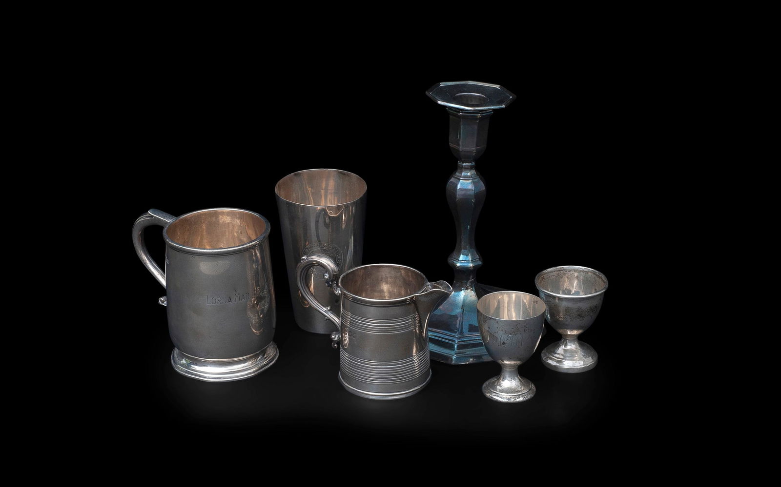 A COLLECTION OF 19TH AND EARLY 20TH CENTURY SILVER: comprising an early 20th century silver half pint mug, hallmarked and inscribed 1920, a Victorian silver cream jug, marks worn, a silver beaker engraved London Athletic Club, two silver egg cups and a