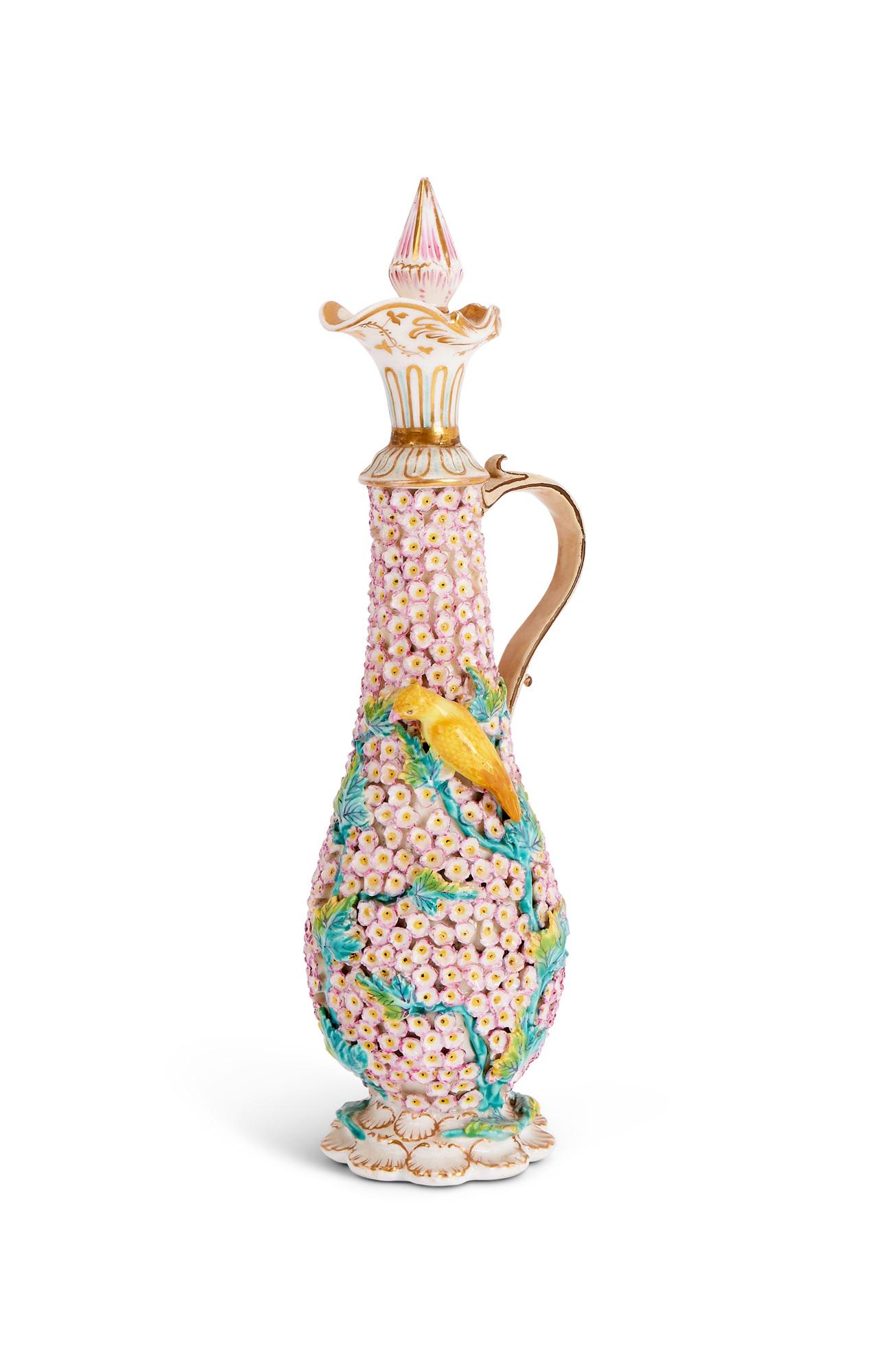 A 19TH CENTURY MEISSEN FLOWER ENCRUSED BOTTLE AND STOPPER: A 19TH CENTURY MEISSEN FLOWER ENCRUSED BOTTLE AND STOPPER A 19TH CENTURY MEISSEN FLOWER ENCRUSED BOTTLE AND STOPPER the ewer of elongated baluster form, the stopper formed as a bud, with scrolling han