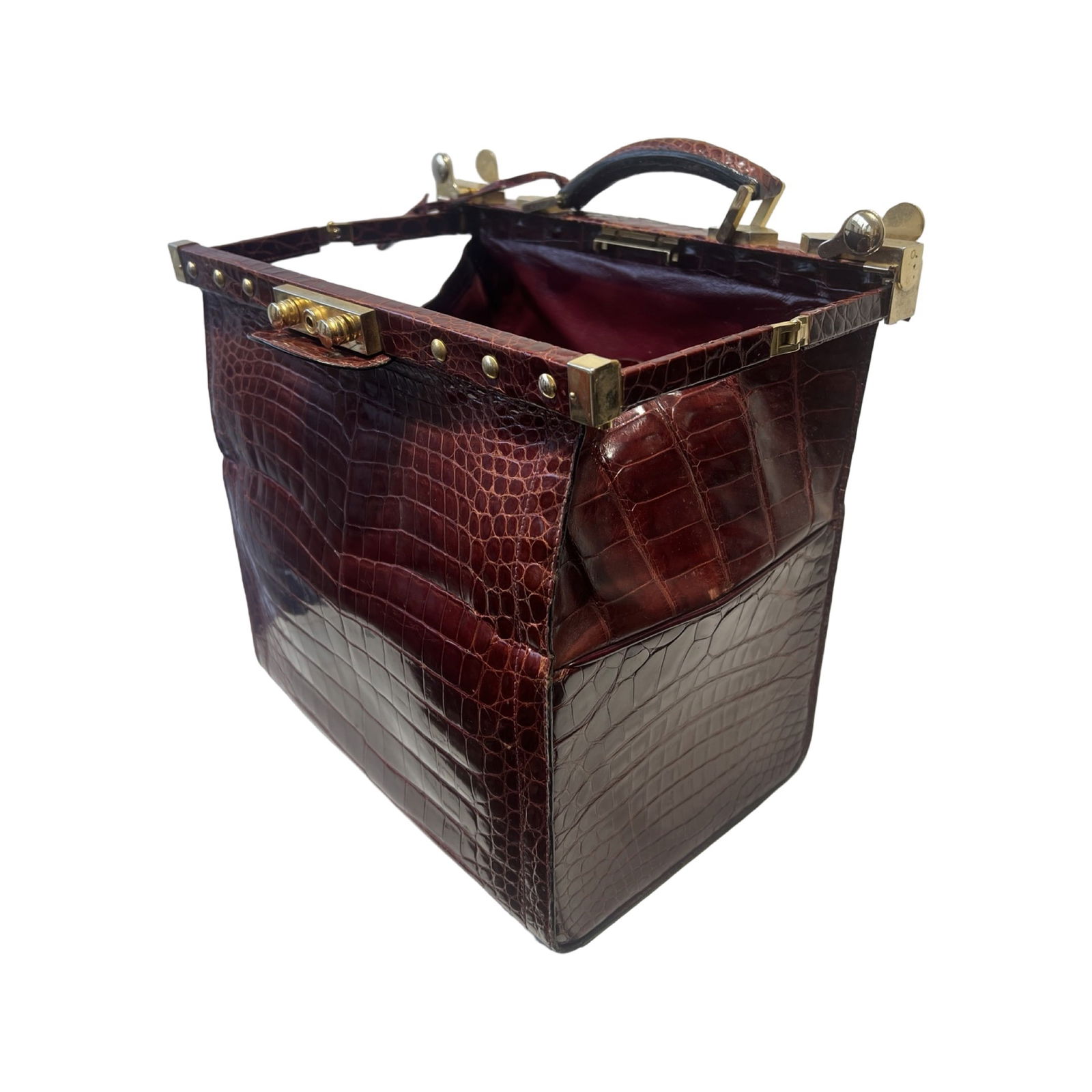 A CROCODILE SKIN AND BRASS MOUNTED BAG: A CROCODILE SKIN AND BRASS MOUNTED BAG in the style of a doctor's bag with label inside 'MAPPIN & WEBB', the clasp opening to an interior with a zipped pocked to each side, 33cm wide x 20cm deep x