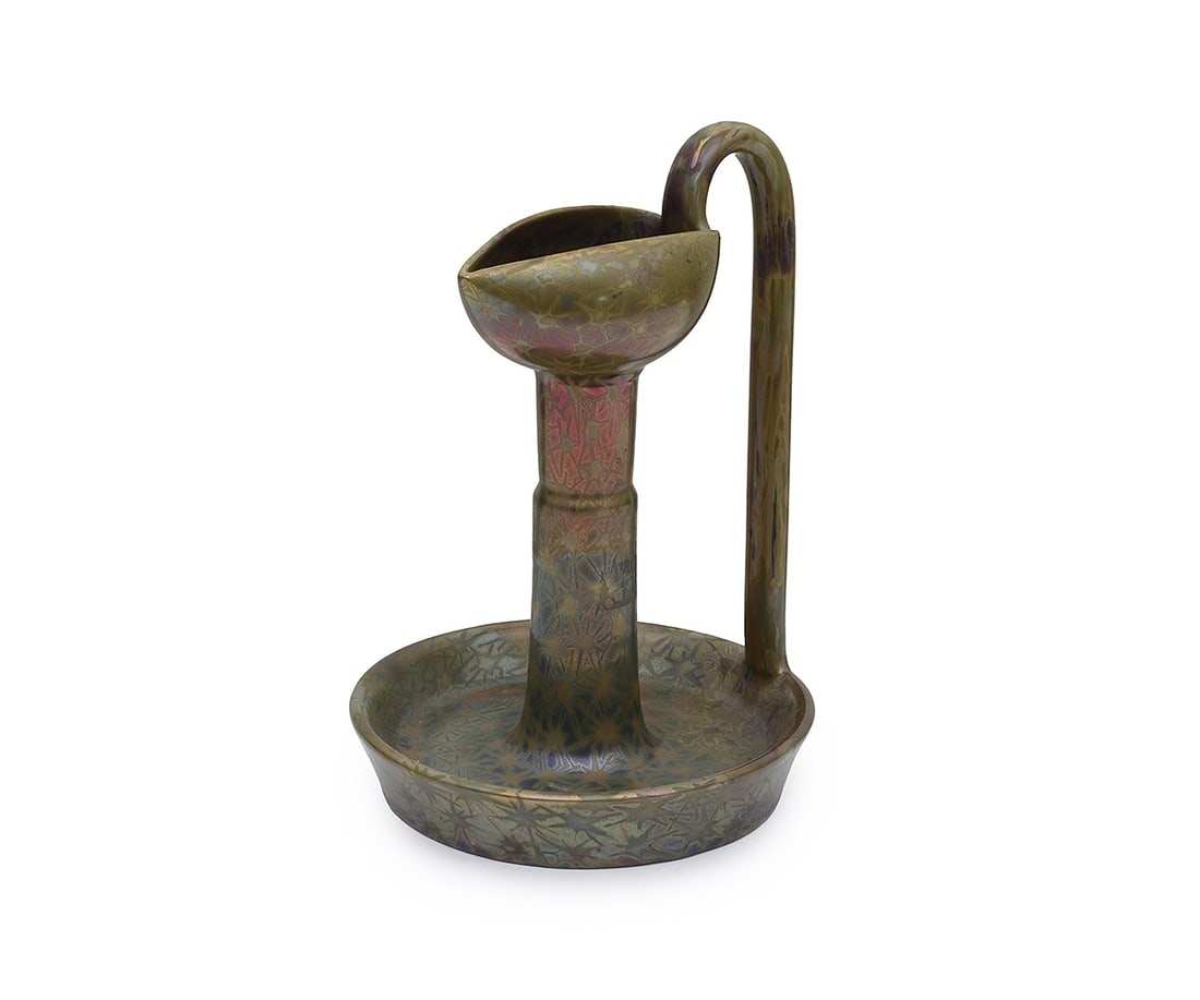 CLEMENT MASSIER: AN IRIDESCENT CANDLESTICK CIRCA 1900: CLEMENT MASSIER: AN IRIDESCENT CANDLESTICK CIRCA 1900 the candlestick or chamberstick of earthenware with lustre glaze, decorated with stylised sunburst pattern, in the Persian / Islamic style, the ca