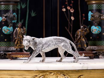 A SILVER MODEL OF A LEOPARD