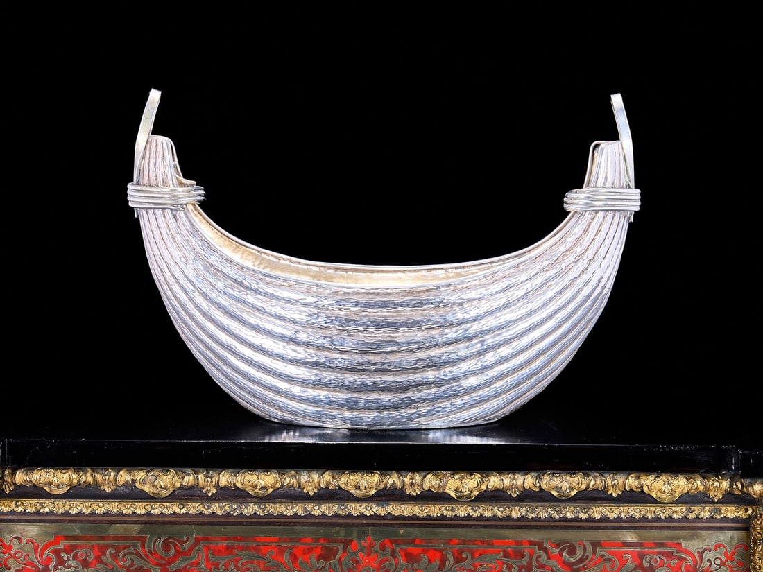 AN ITALIAN SILVER WINE COOLER IN THE FORM OF A BASKET: AN ITALIAN SILVER WINE COOLER IN THE FORM OF A BASKET the champagne or wine cooler in the form of a boat shaped basket with trellis texture to the body and faux rope tied to the ends, with twin handle