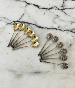 A SET OF TWELVE RUSSIAN SILVER GILT AND ENAMELLED SPOONS: A SET OF TWELVE RUSSIAN SILVER GILT AND ENAMELLED SPOONS the antique coffee spoons with cloisonne enamel decoration, marked 84, 10.3cm in length (12)