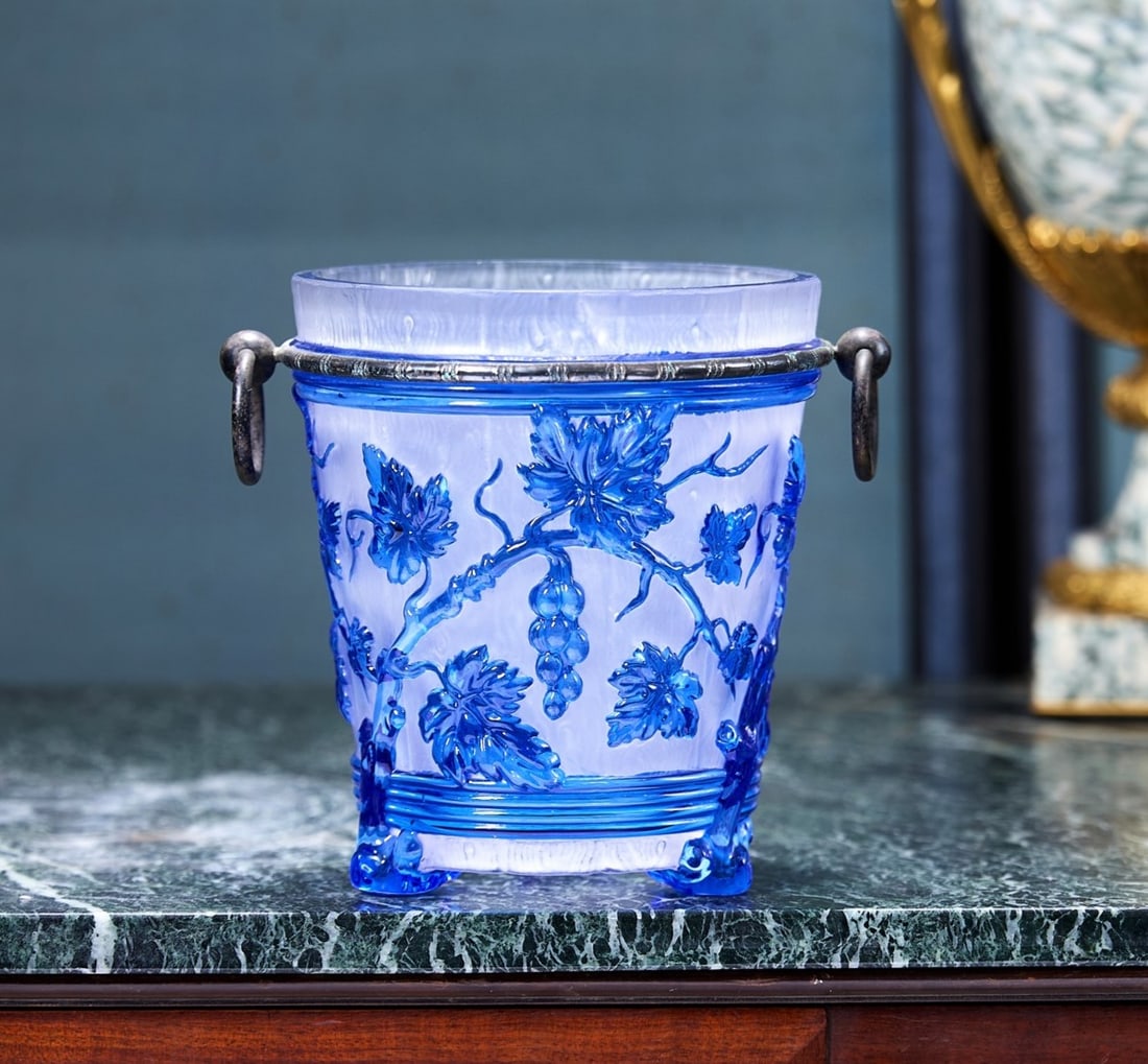 BACCARAT: A 19TH CENTURY BLUE AND CLEAR CRYSTAL GLASS CHAMPAGNE BUCKET: BACCARAT: A 19TH CENTURY BLUE AND CLEAR CRYSTAL GLASS CHAMPAGNE BUCKET C. 1860, the French antique glass wine cooler in pressed crystal glass, the bucket formed as a barrel decorated witih grapes and